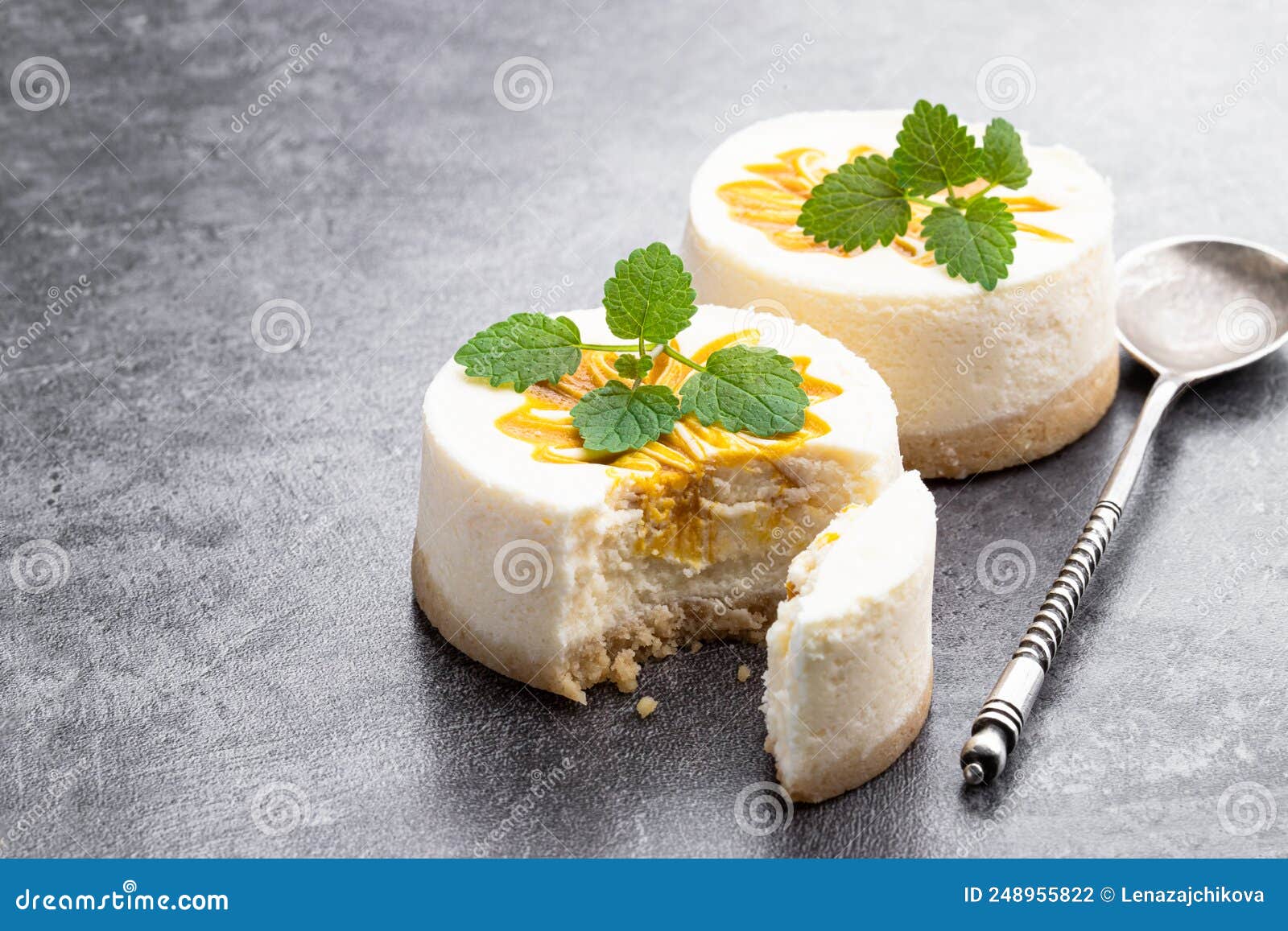 Mini Cheesecakes Decorated with Yellow Jam on Gray Background Stock