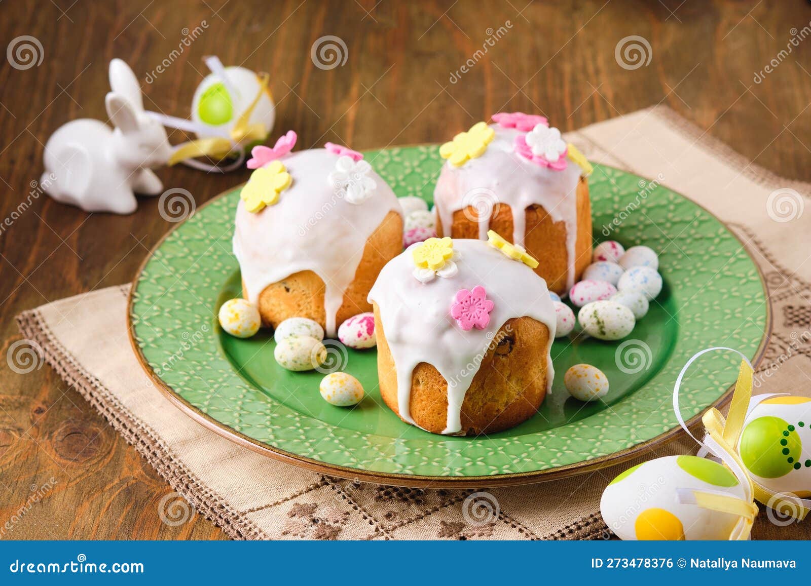 Mini Easter Cakes Covered with Icing and Decorated with Sugar Flowers 