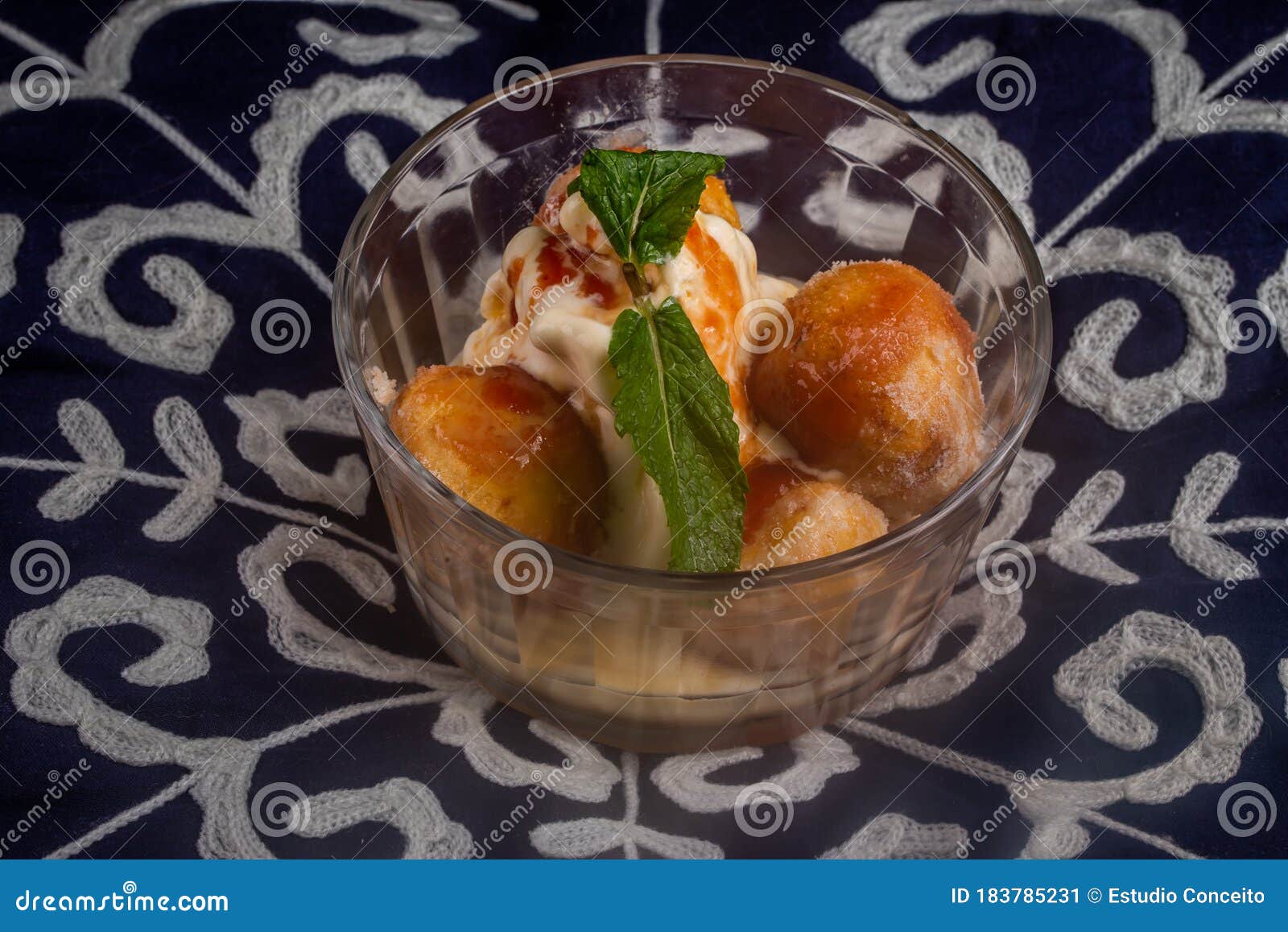 mini fried cakes with sugar and traditional cinnamon from brazil where they are called a bolinho de chuva. pictured is served with