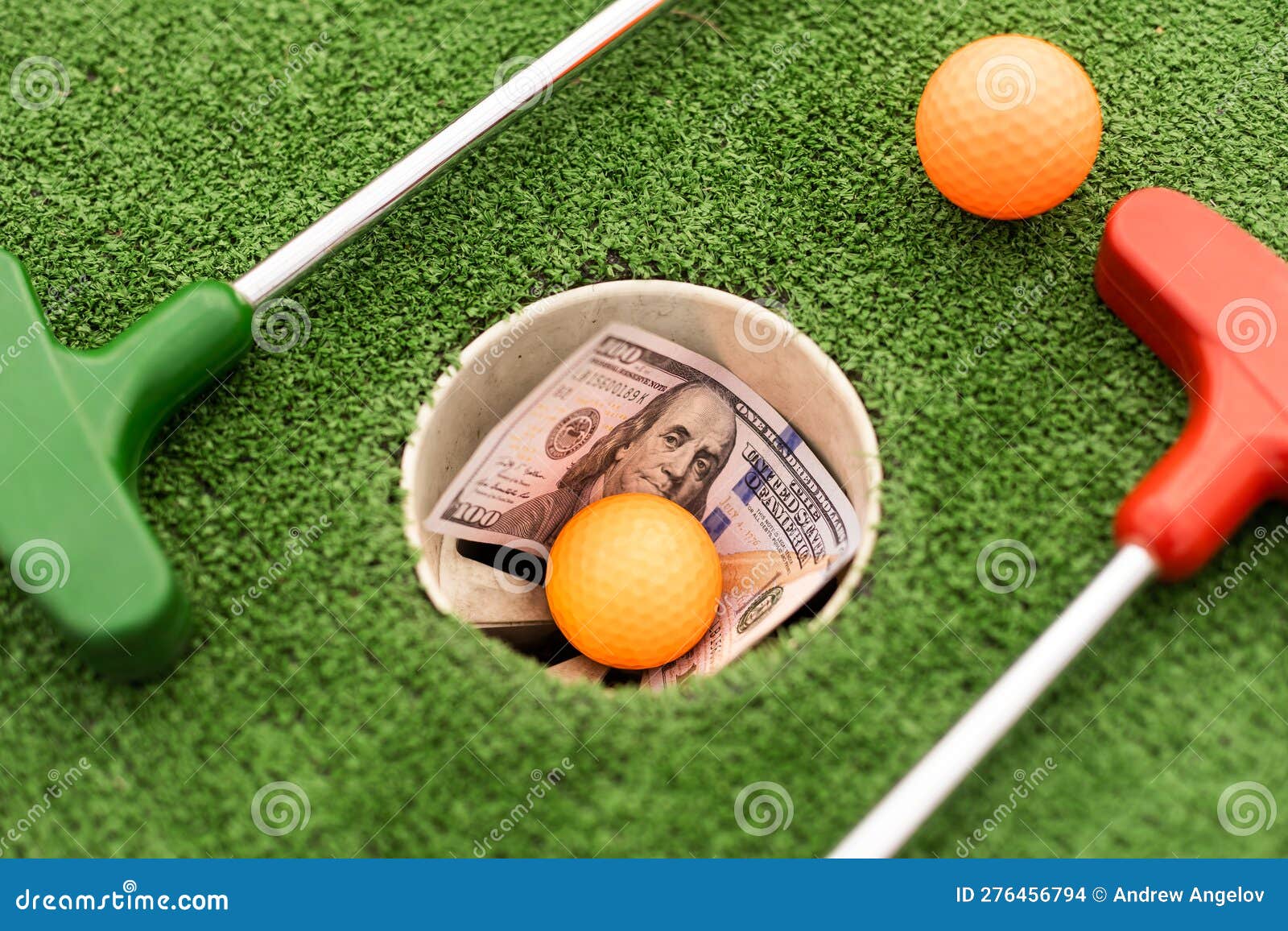 Mini Golf Club, Ball and Money on the Artificial Grass Stock Photo