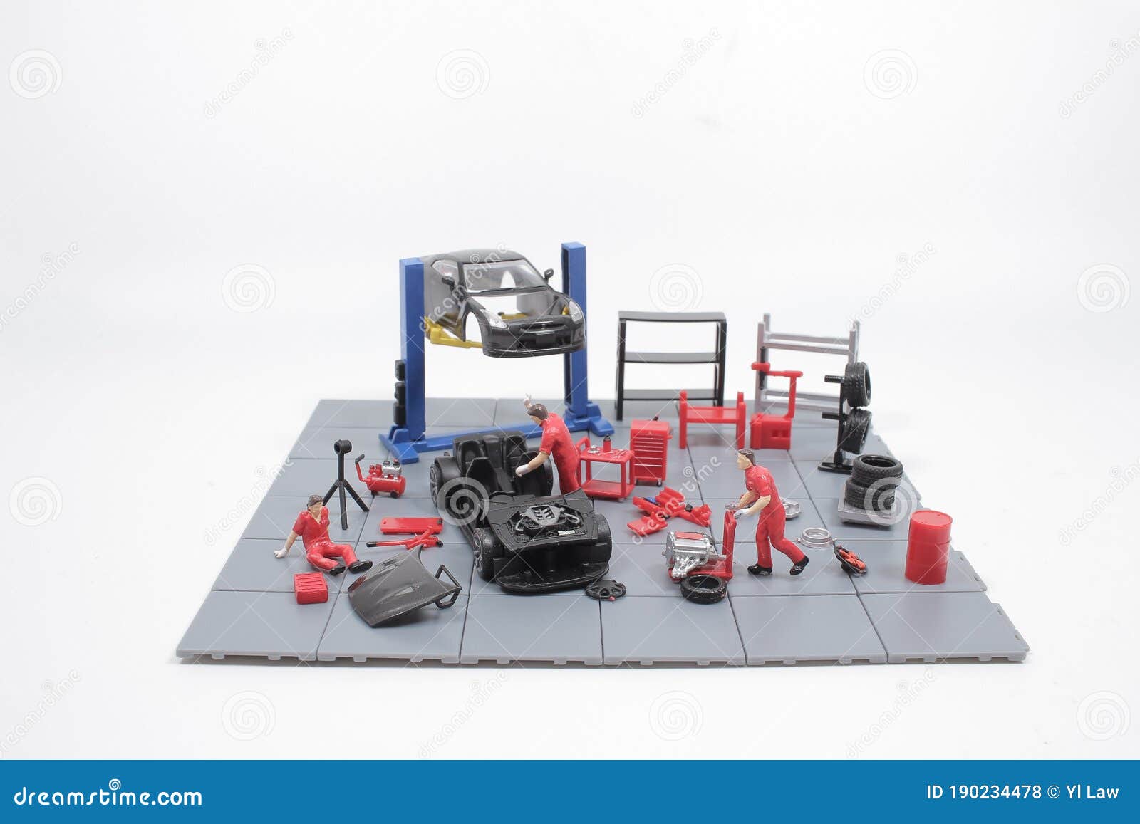 A Mini Mechanics Repairing Toy Car,concept of the Stock Photo