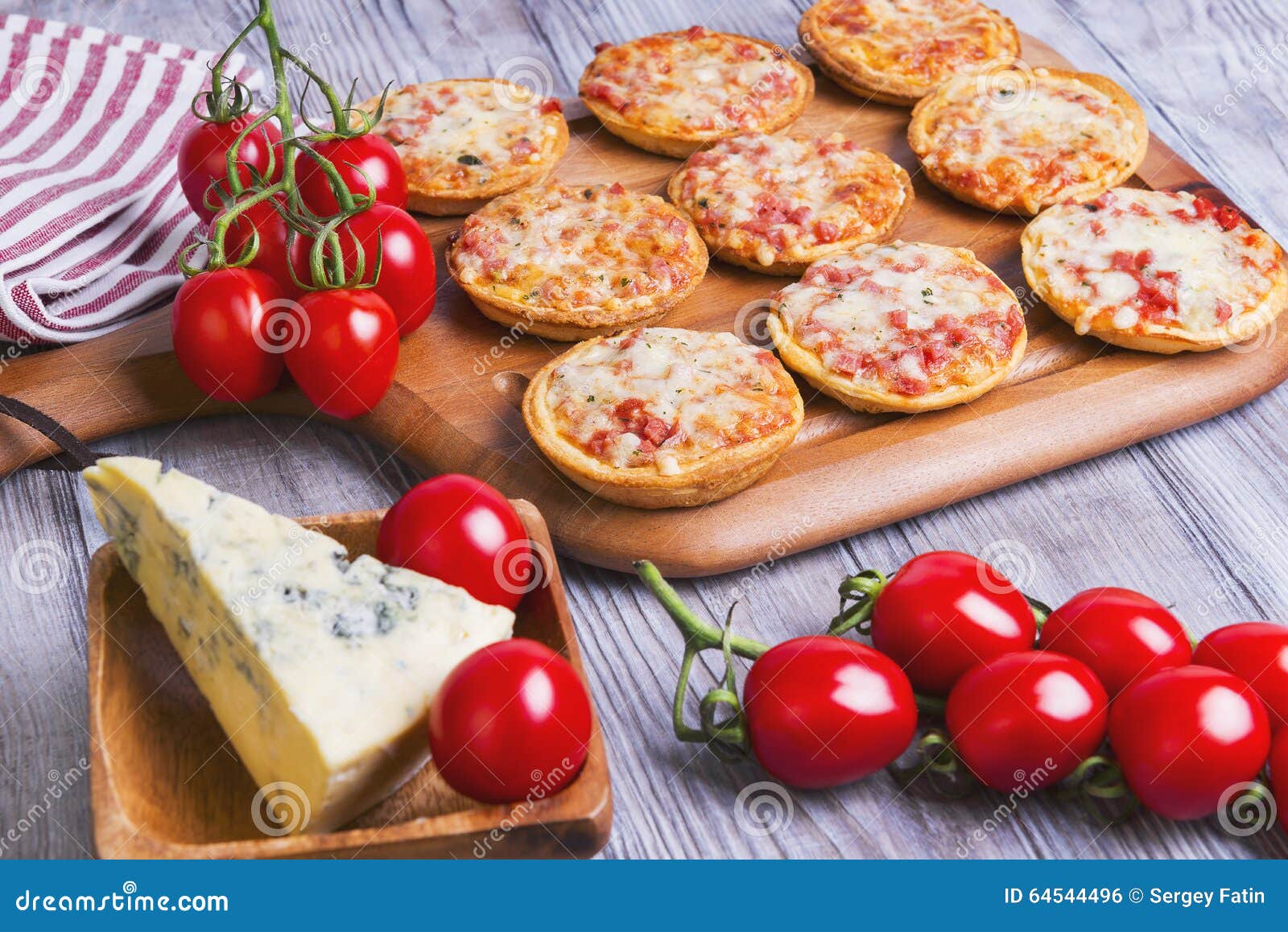 Mini Pizzas on a Wooden Table Stock Photo - Image of cooking, closeup ...