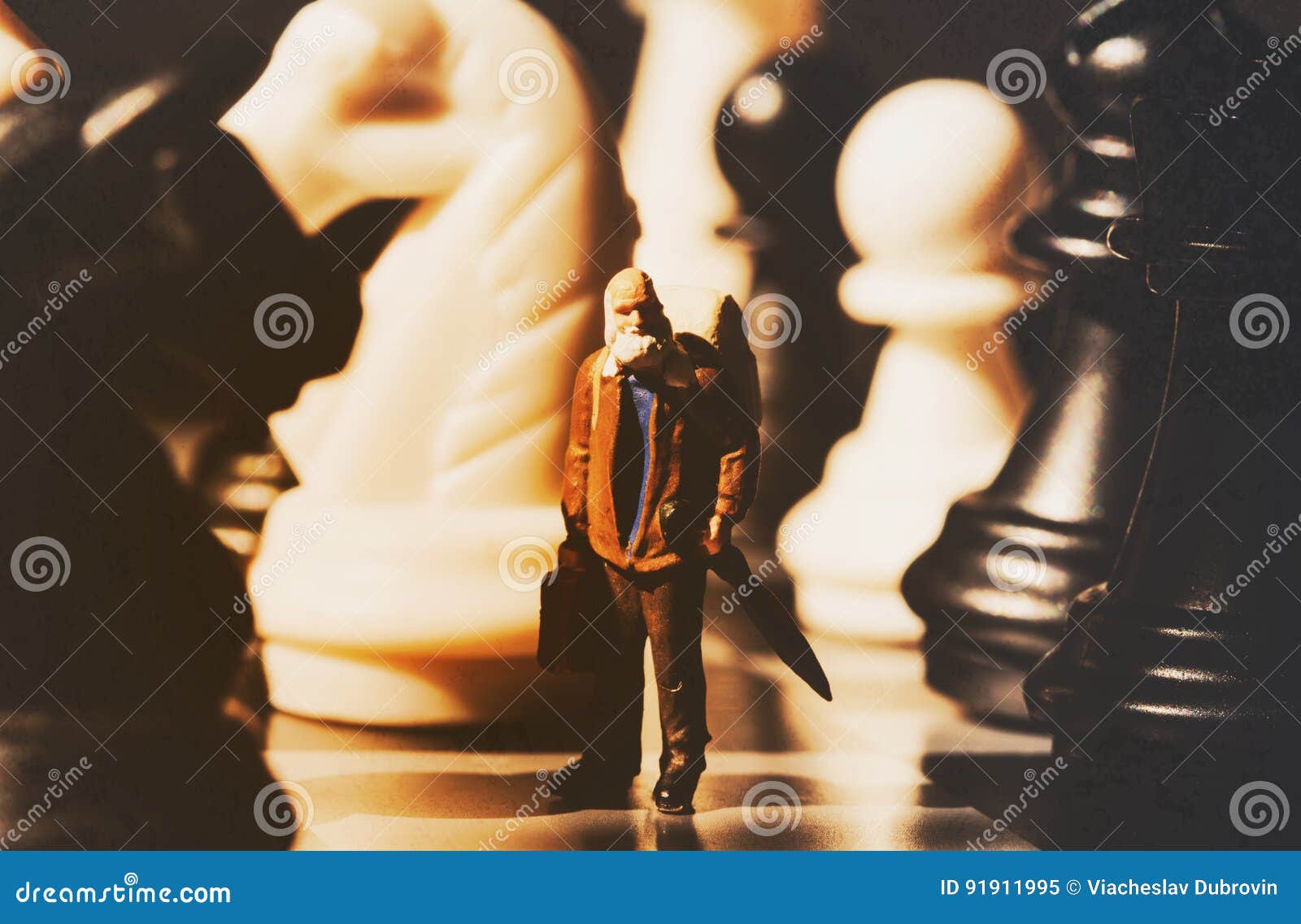 miniature doll and chess vintage toned photo. old traveler on chessboard.