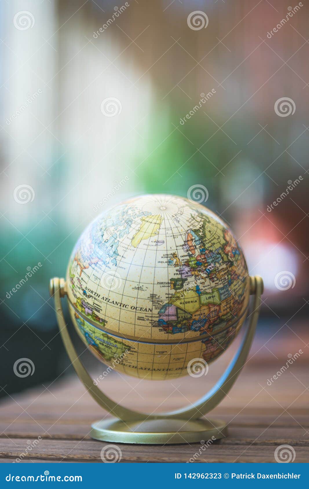 miniature globe model on a rustic wooden table.  for travelling