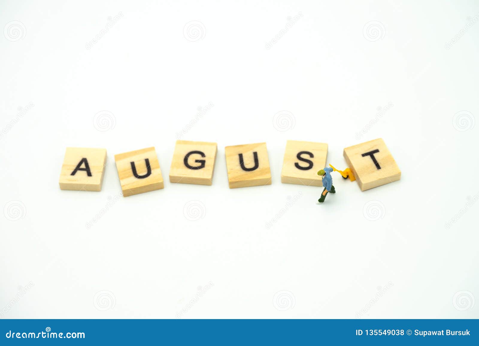 Miniature people Construction worker standing with wood word Month. using as background business concept and calendar concept with copy space for your text