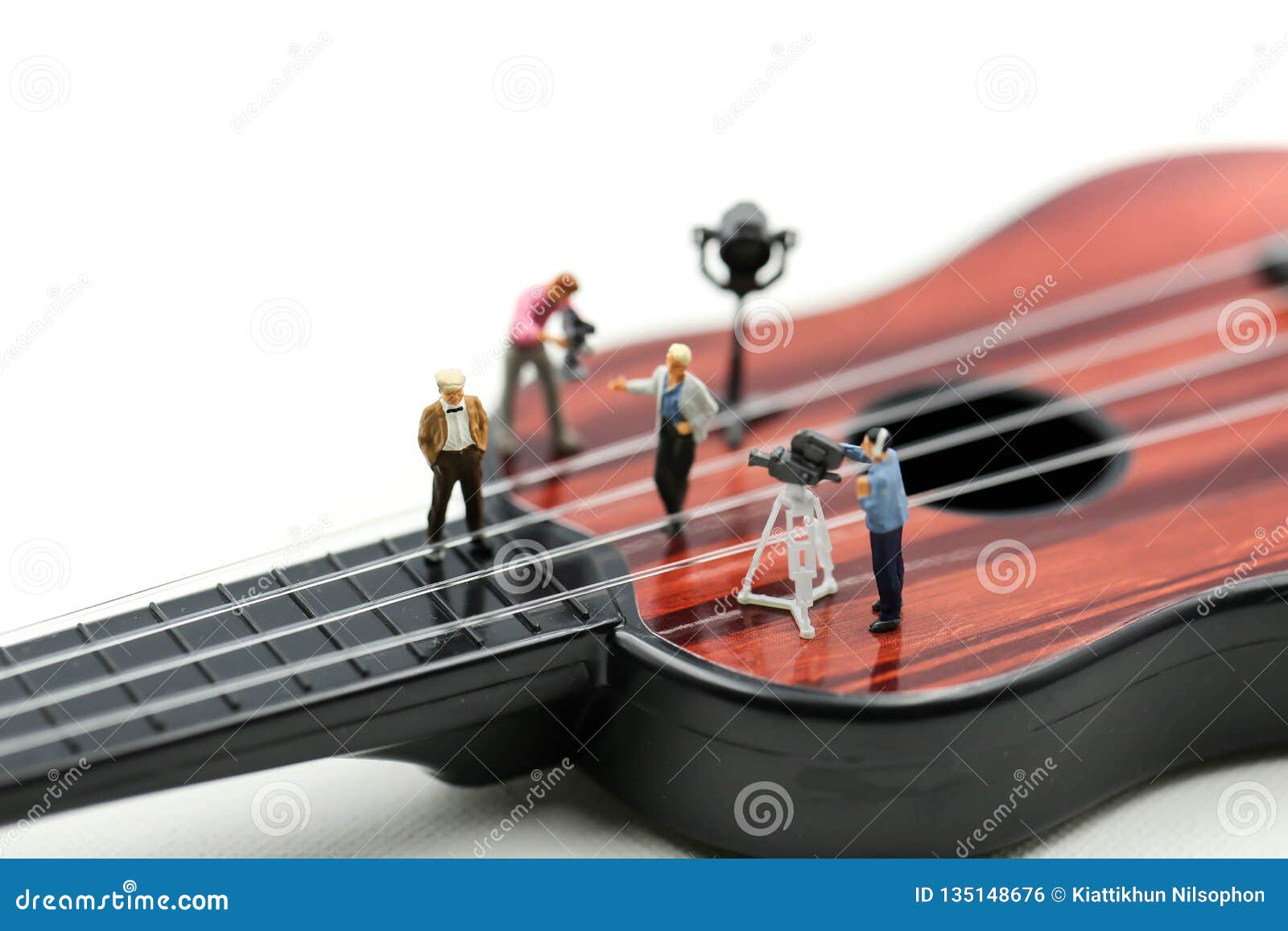 Miniature people : Director, staff and actors on the set of the video singer with guitar,production music concept.