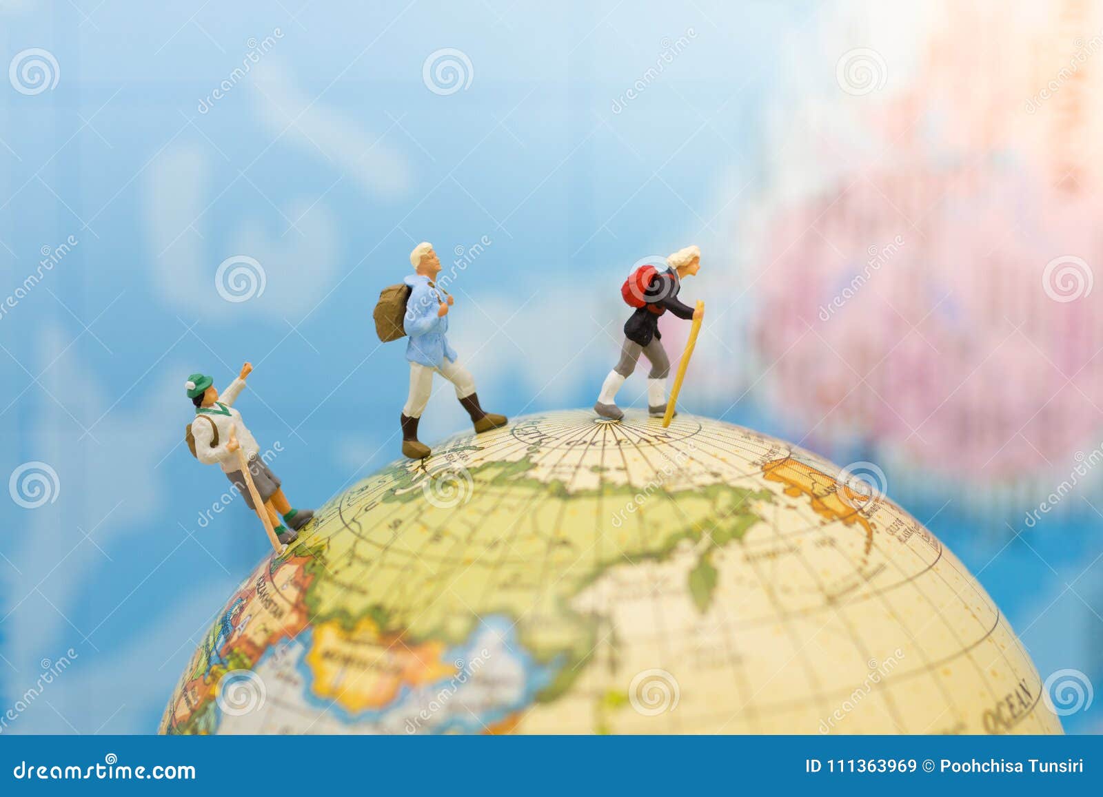 miniature people: group traveler backpack stand and walking on world map. image use for travelling or business trip concept
