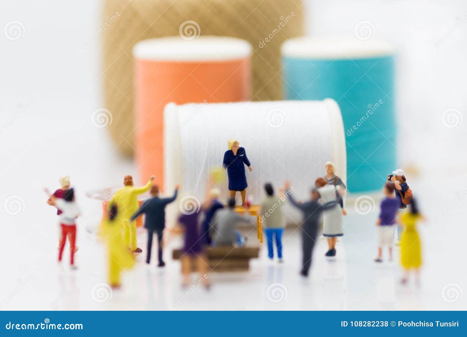 miniature people: group women weaving factory protest. image use for claims or benefits should be earned from hard work