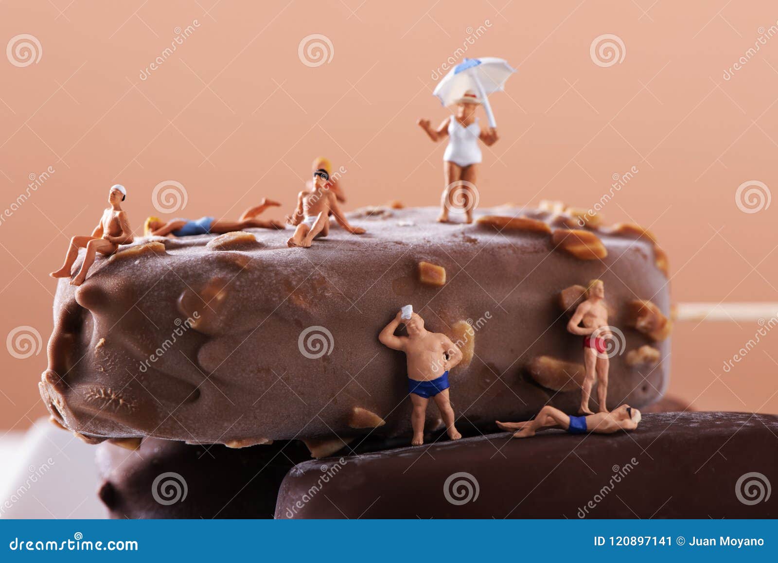 miniature people in swimsuit on an ice cream bar