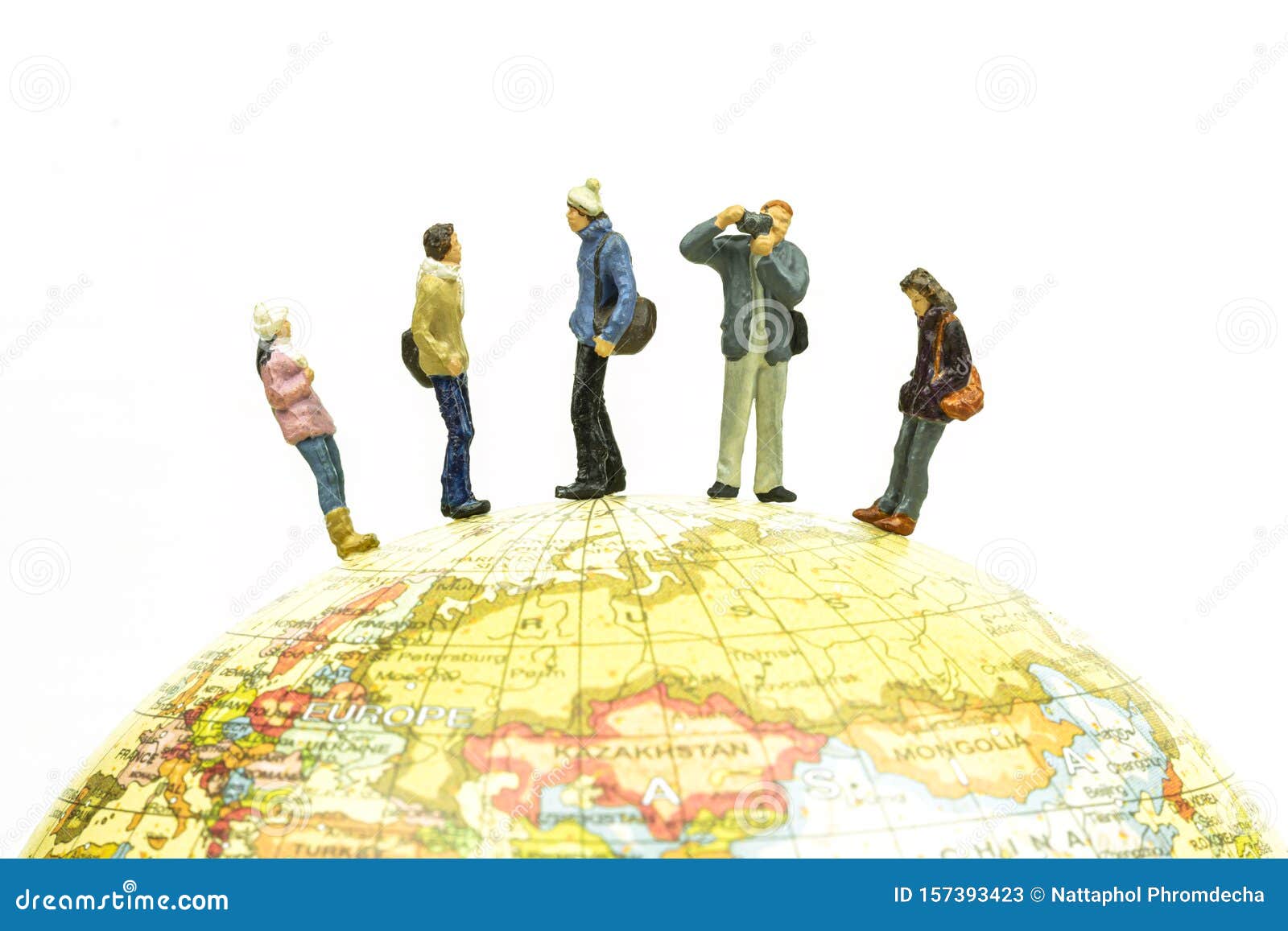 Miniature people travel around the globe close up. Image concept.