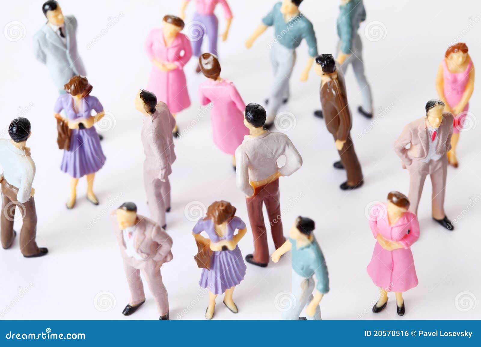miniature toy people stand in different poses