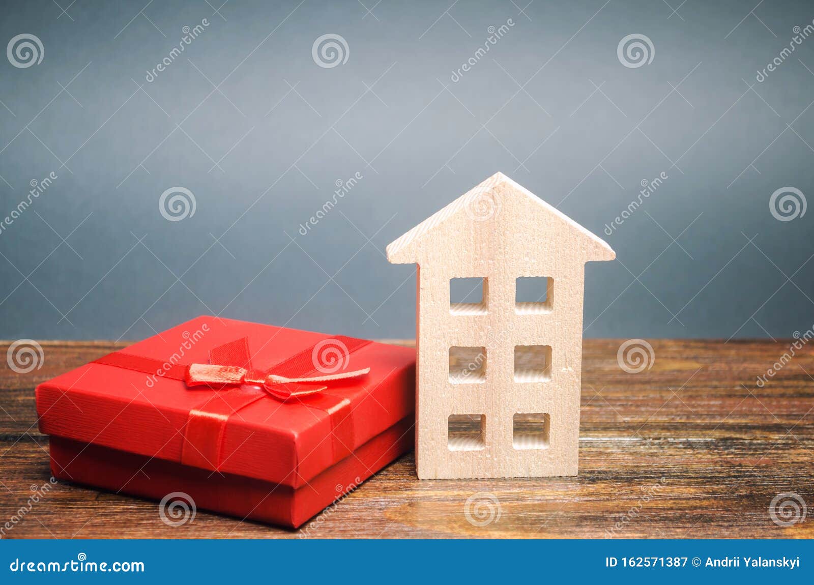 miniature wooden house and gift box. the concept of profitable offers for the purchase of real estate. inheritance of housing.