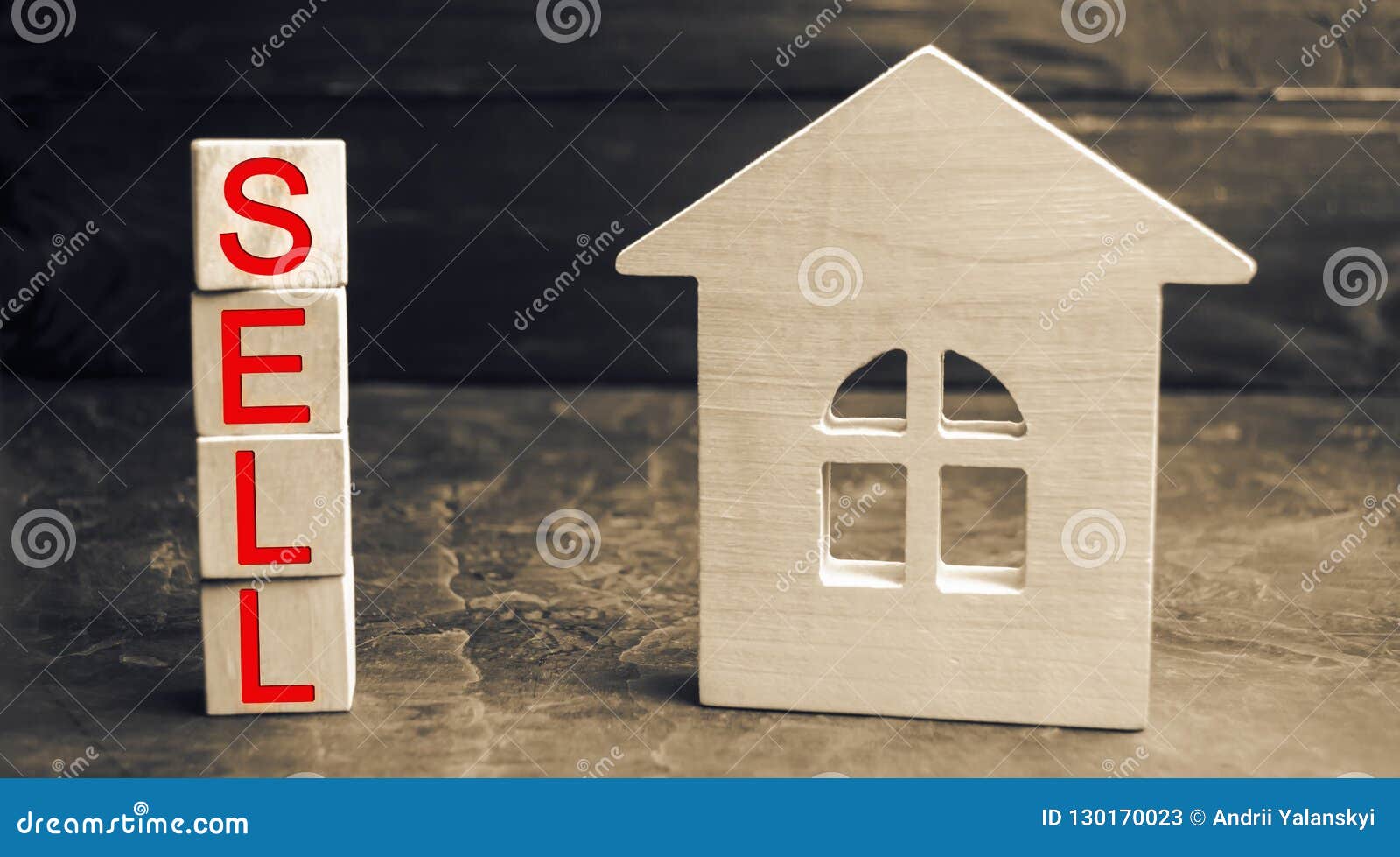 miniature wooden house and the inscription ` sell `. real estate concept. sell of a home, apartment property sell. affordable hous