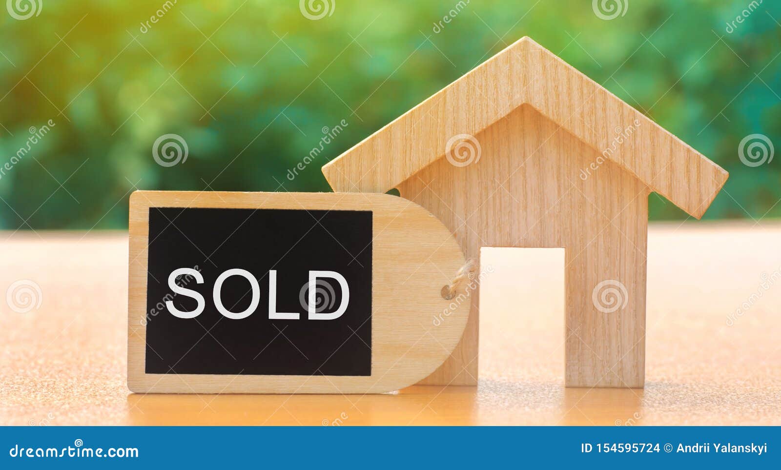 a miniature wooden house and inscription sold. the concept of selling a home or apartment. property for sale. affordable housing.