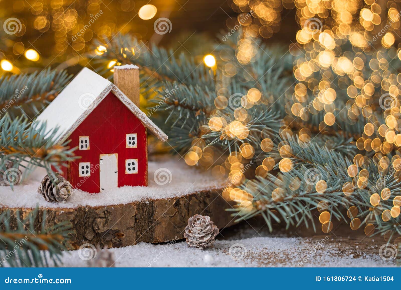 Miniature Wooden House on the Snow Over Blurred Christmas Decoration ...