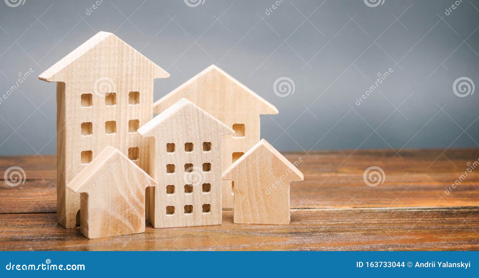 miniature wooden houses. real estate. city. agglomeration and urbanization. market analytics. demand for housing. rising and