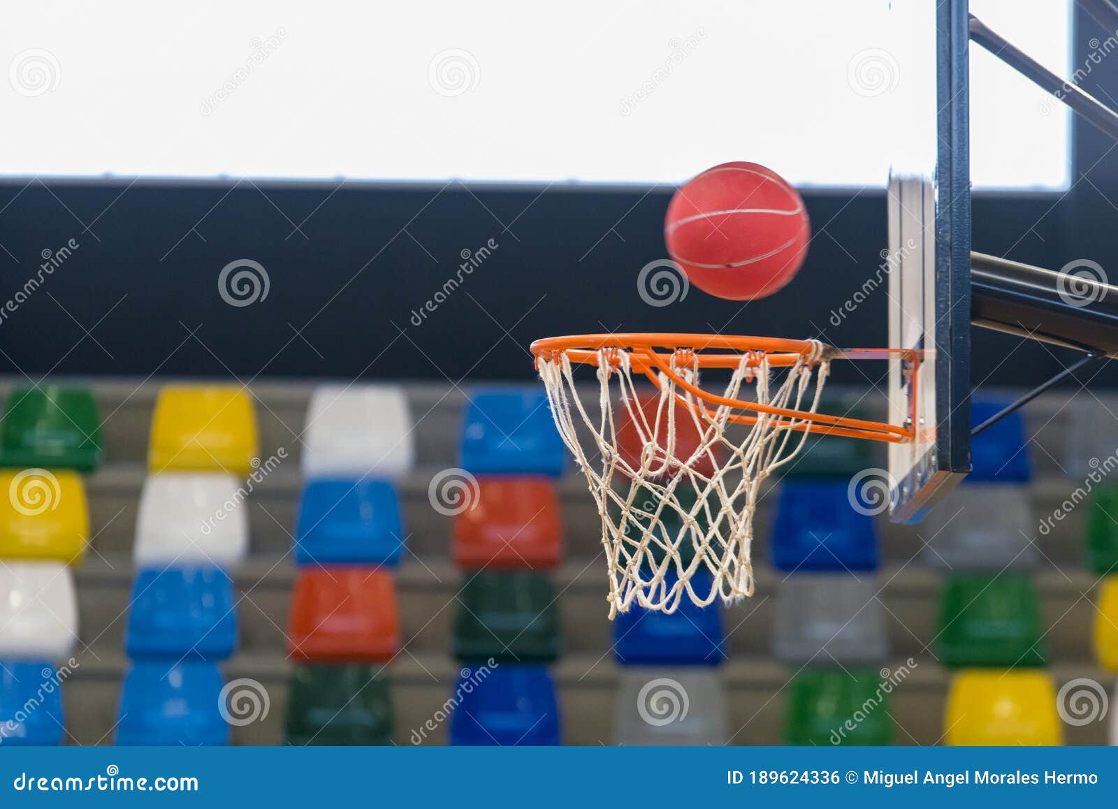 detail of a basketball about to enter the basket