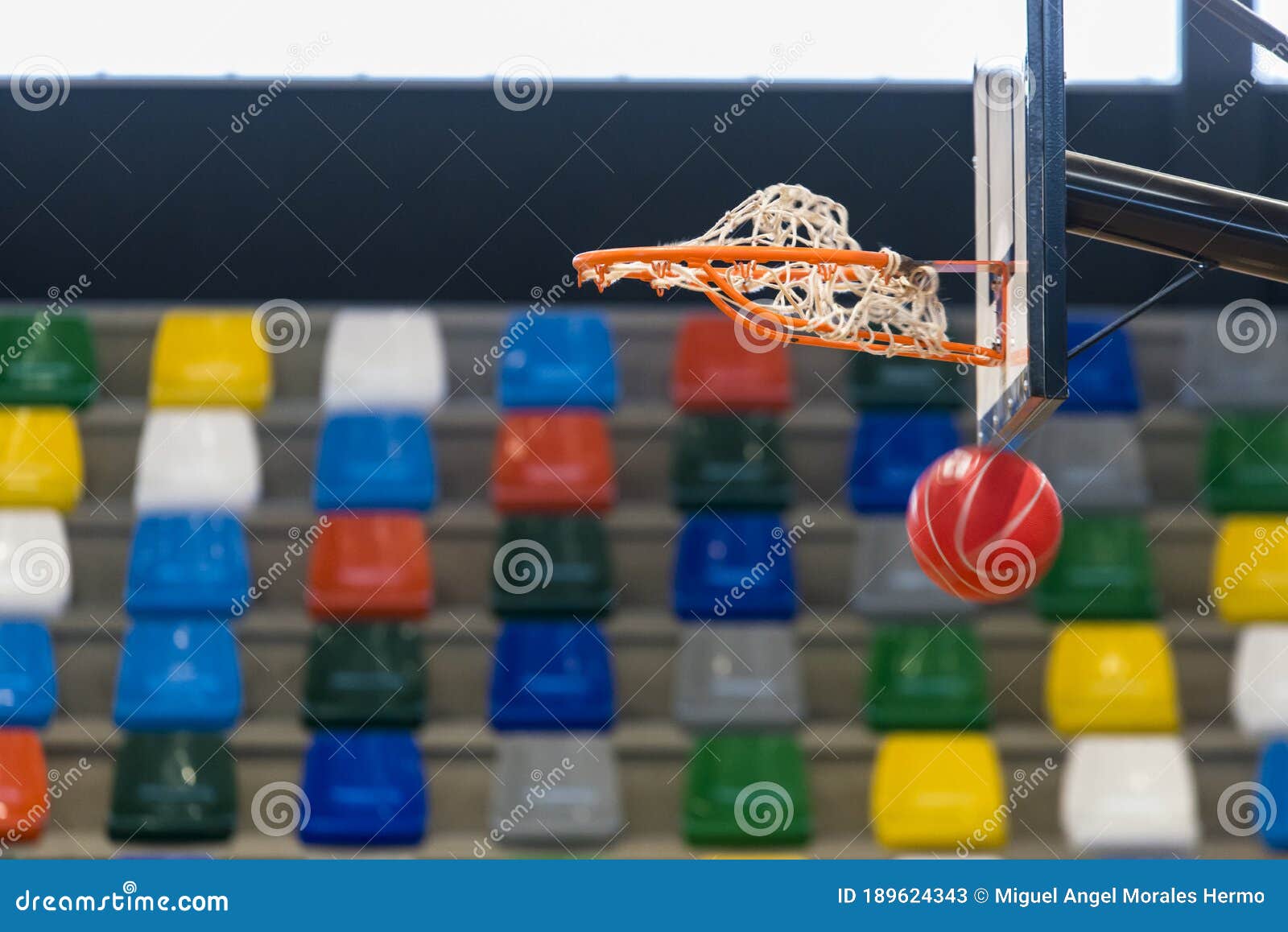 a red ball goes through a basketball basket