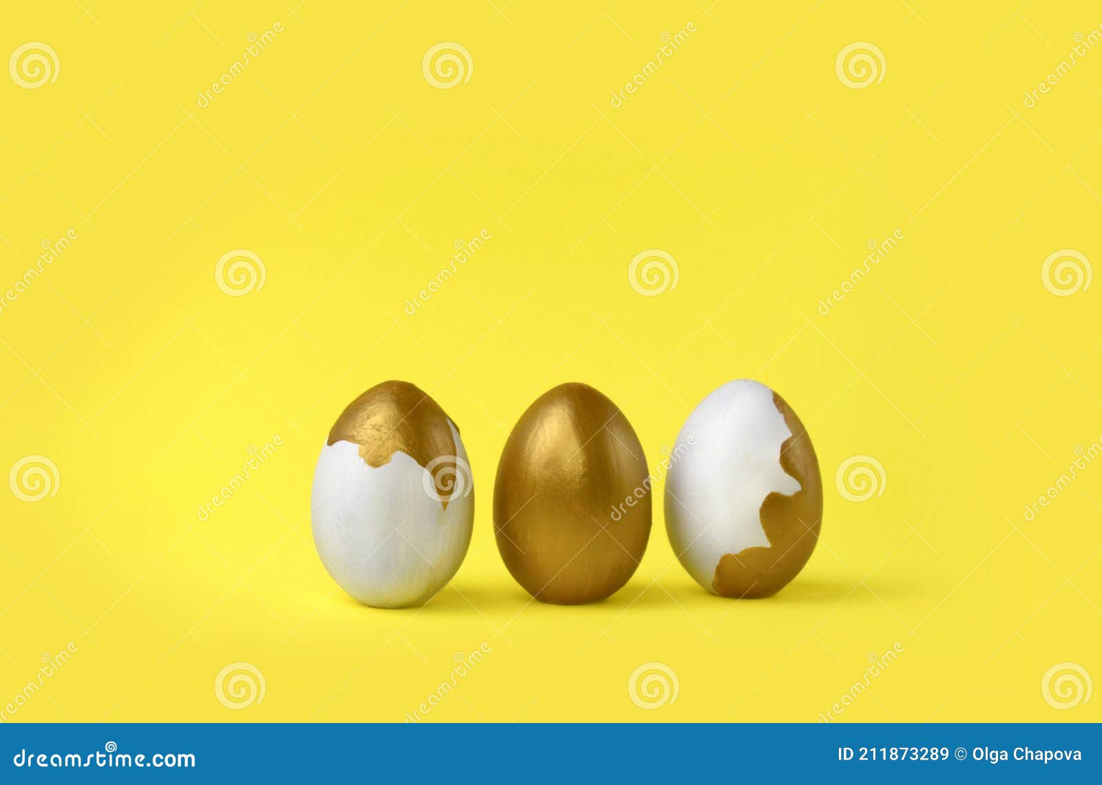 minimalist easter composition. golden decorated eggs in row on yellow background.