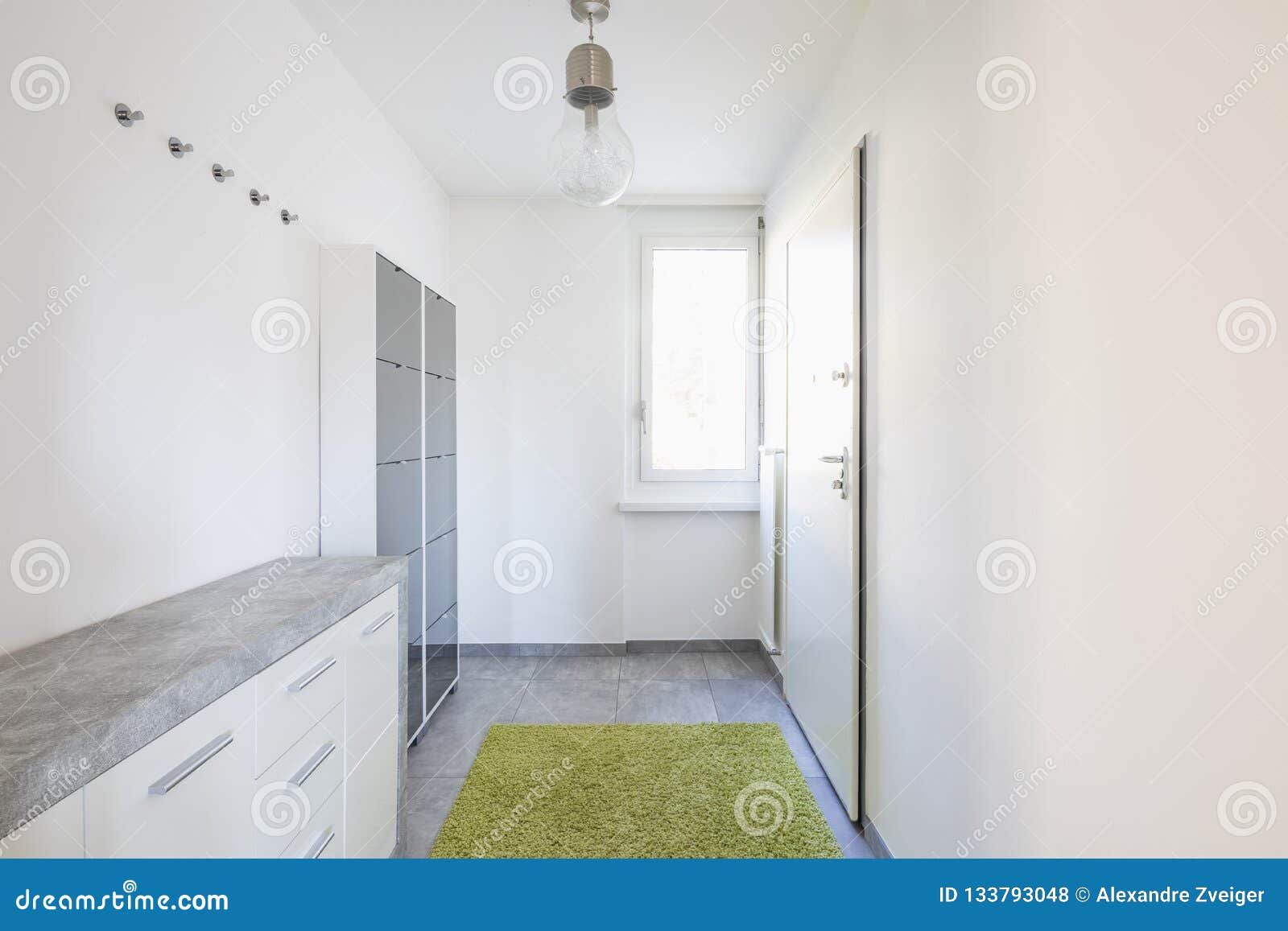 Minimalist Entrance With Shoe Rack And Carpet Stock Photo