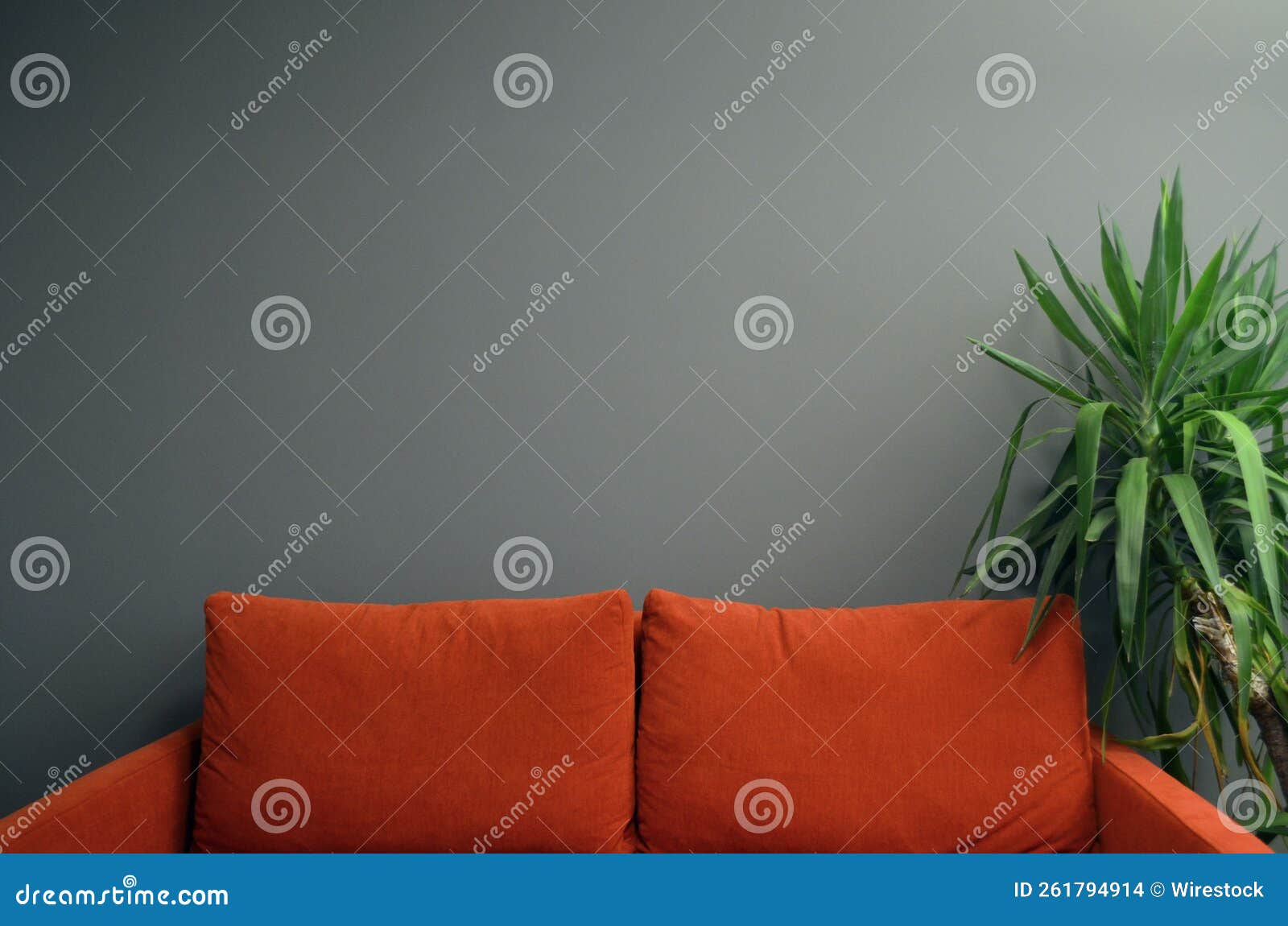 Minimalistic Orange Sofa Against the Grey Wall Stock Photo Image of