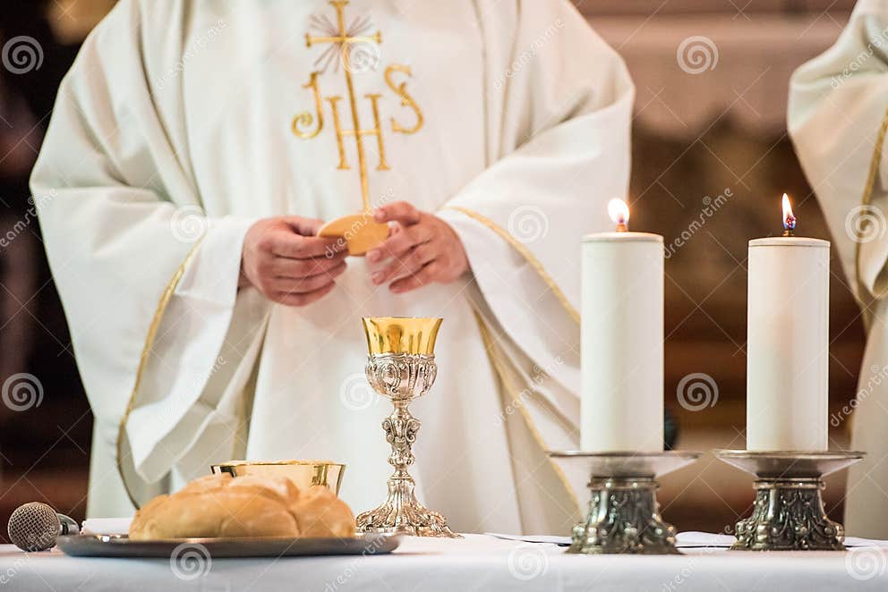 Priest giving Eucharist stock photo. Image of eucharist - 173713618