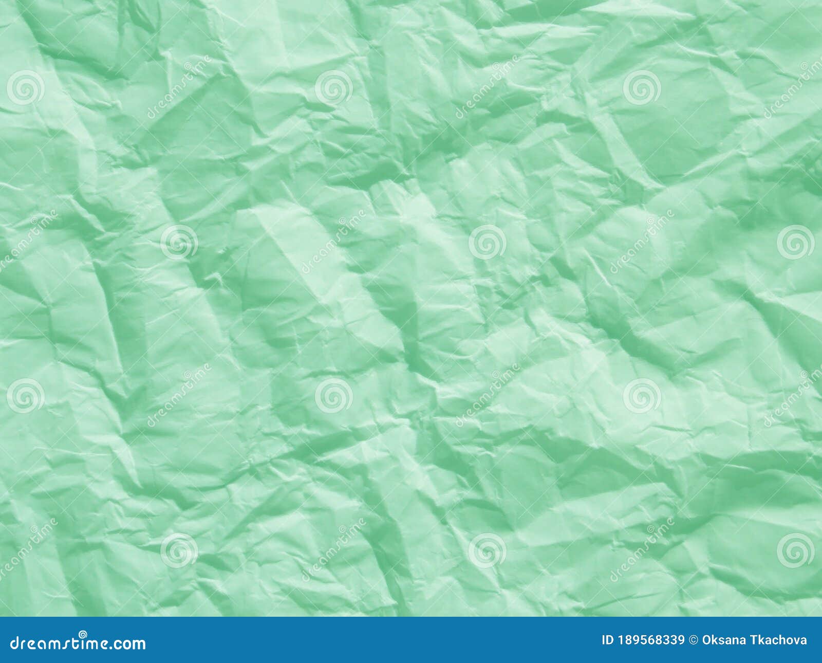 Crumpled mint green paper textured background