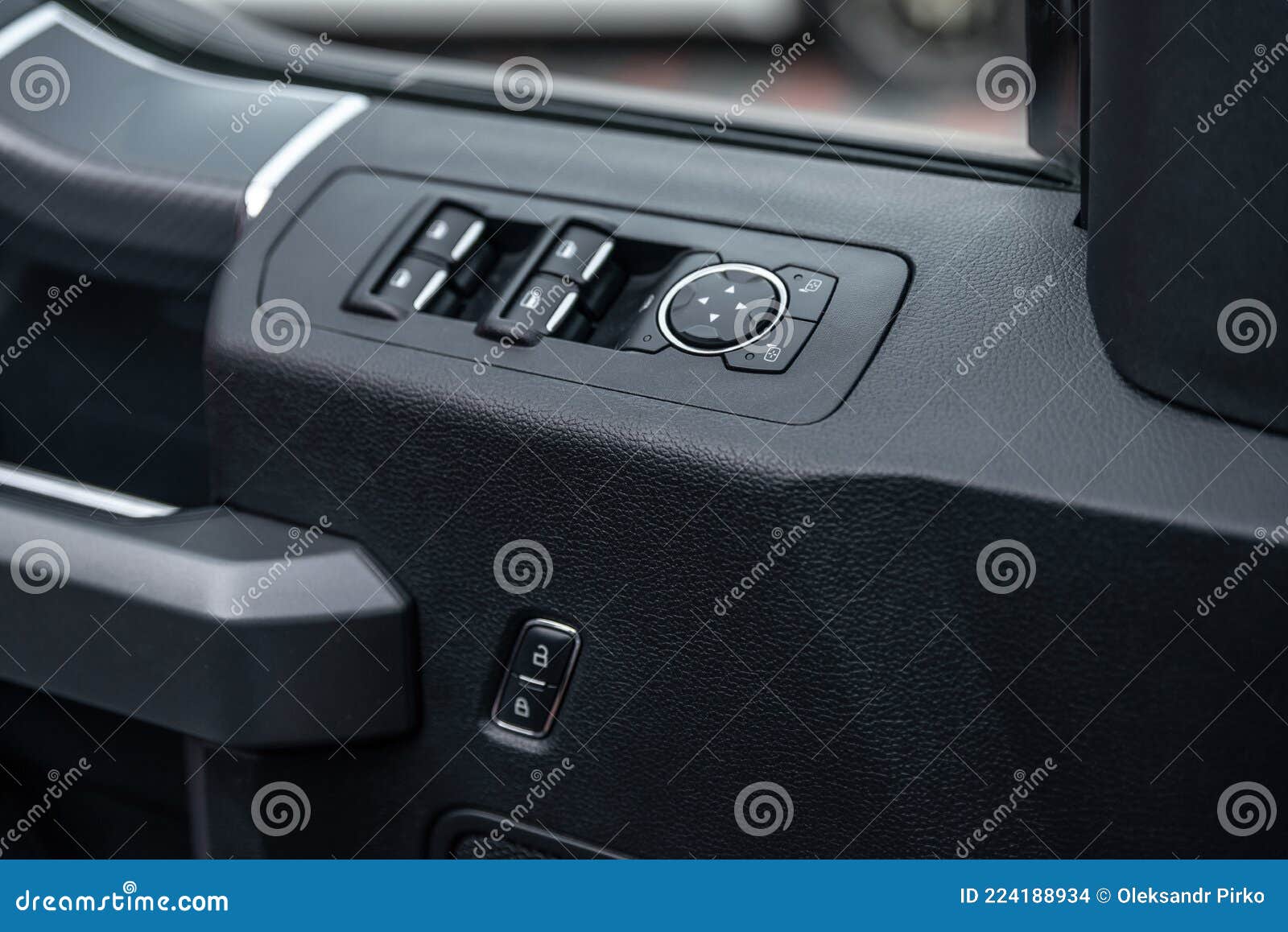 mirror control knob and window control panel in a modern car. automatic car window controls and details. car door lock