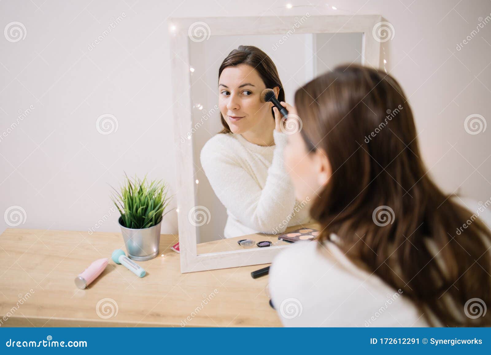 mirrored image of a girl blushing her cheekbone