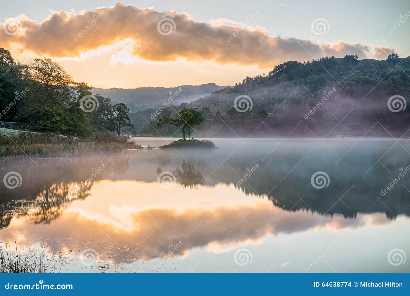 mirrored sunrise on rydal water, in the lake district