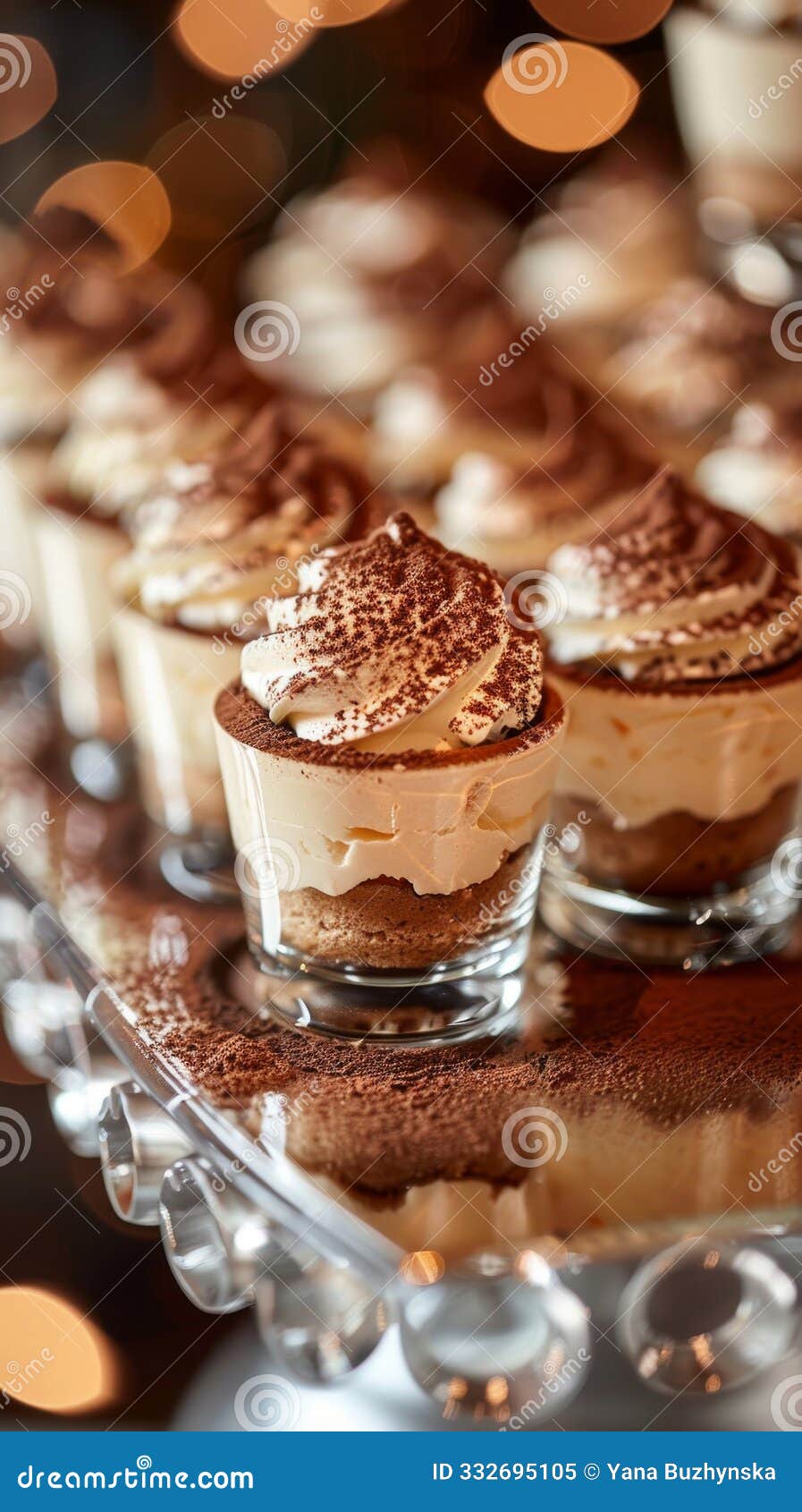 mirrored tray with tiramisu cups, featuring espresso-soaked fingers, mascarpone filling, and cocoa powder