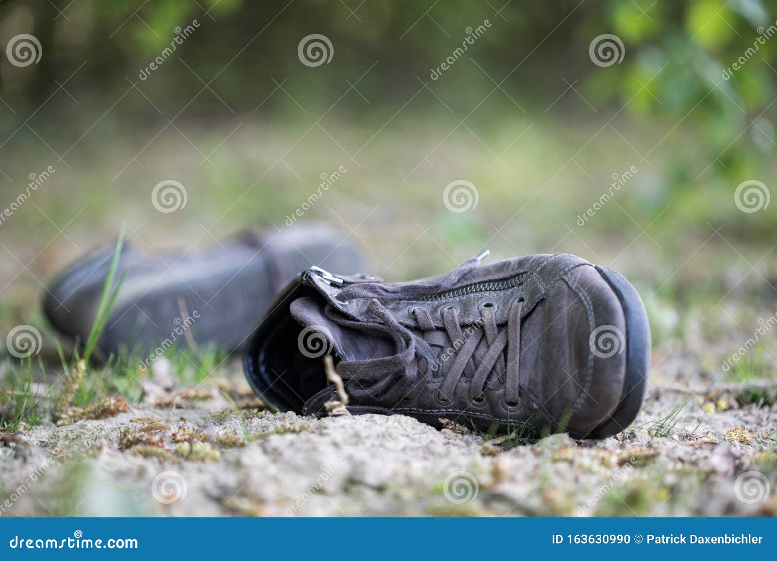 Missing and Poverty Concept: Abandoned Shoe Lying on the Dusty Ground ...