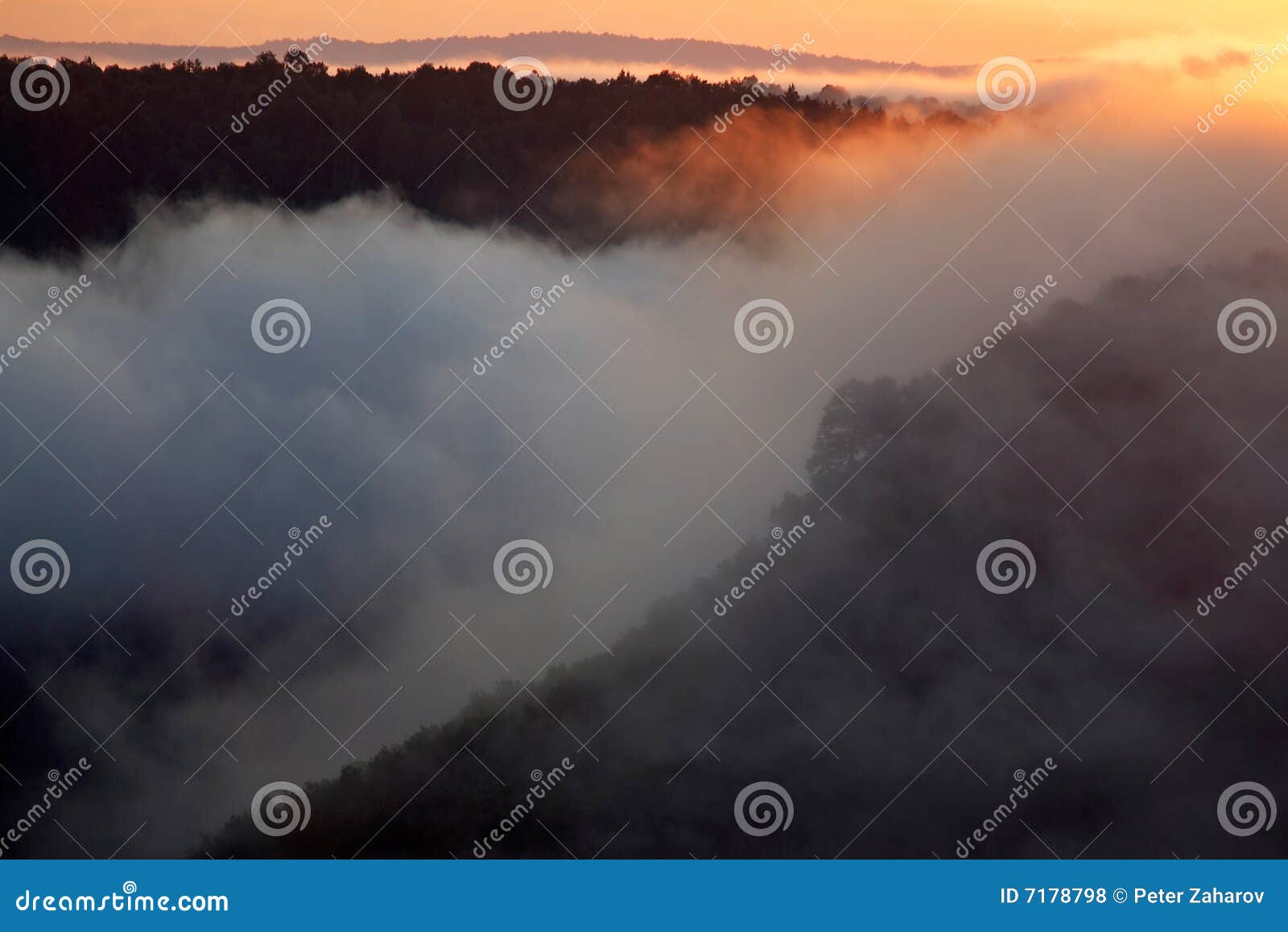 misty morning of hilly area with ray of light.