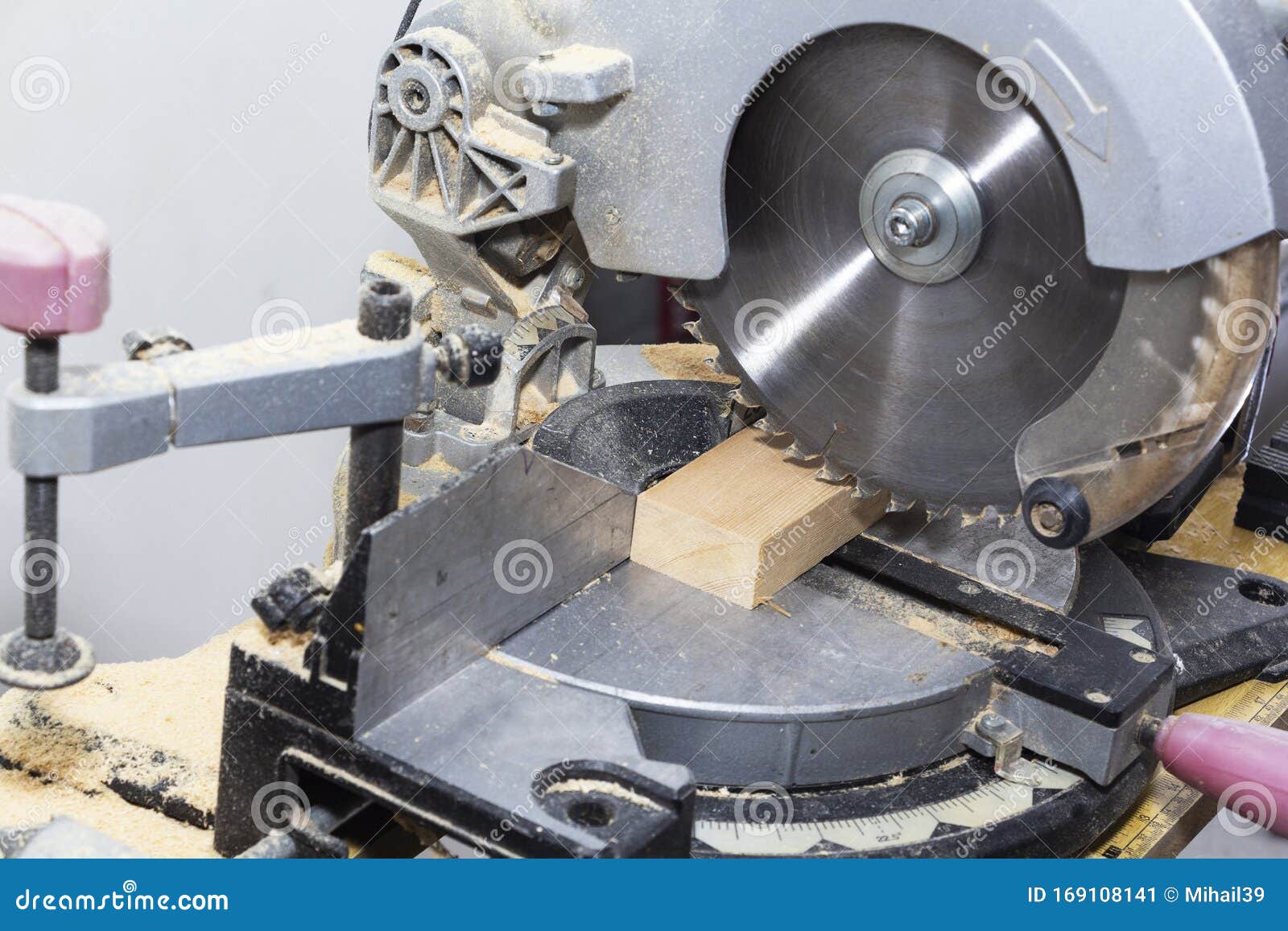 A Miter Saw Making a Compound Cut through Construction Lumber Stock