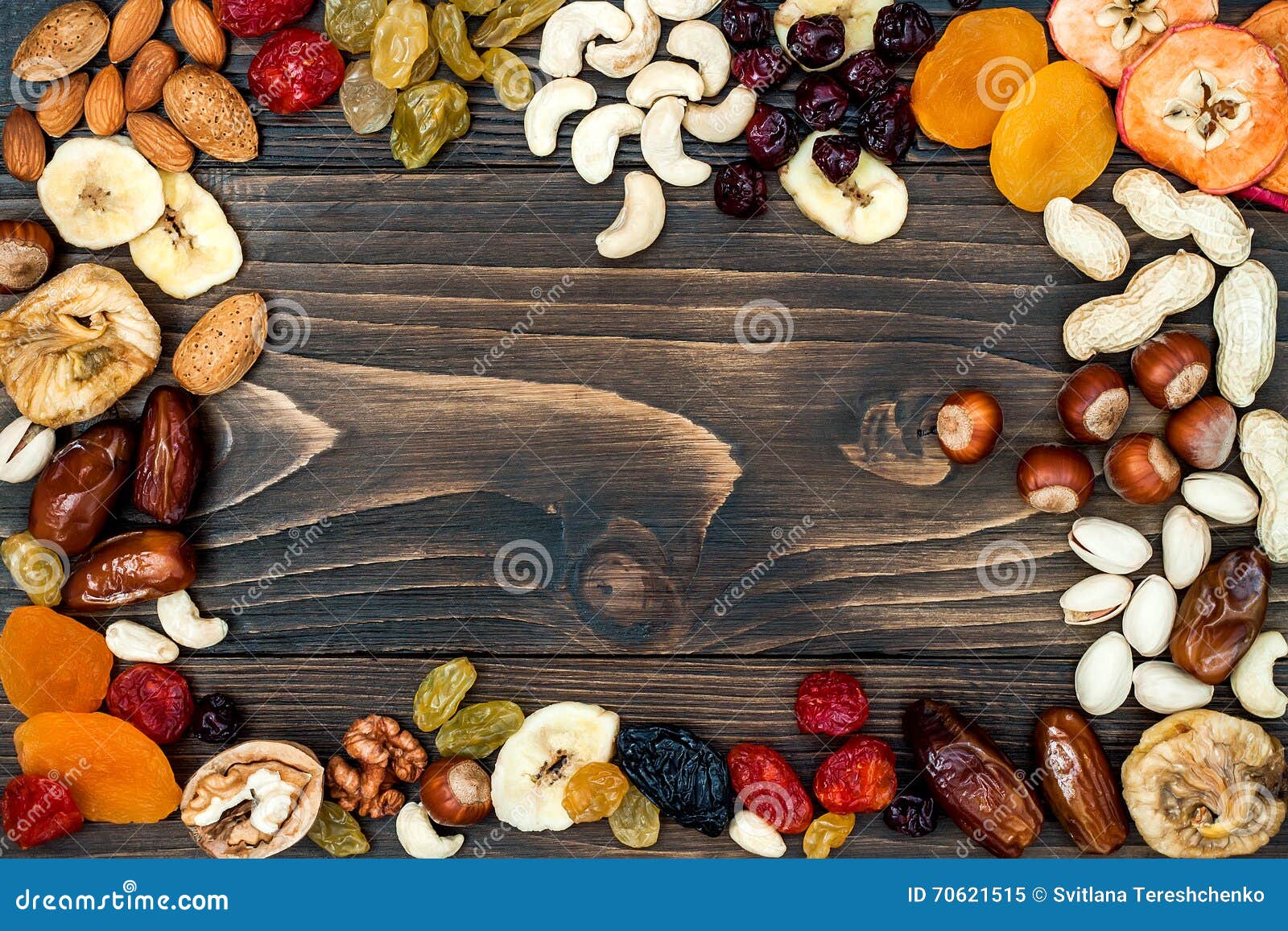mix of dried fruits and nuts on a dark wood background with copy space. top view. s of judaic holiday tu bishvat.