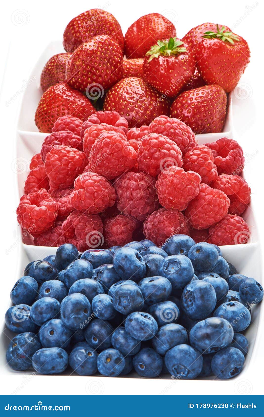 a mixed arrangement. assorted berries including blueberries, raspberries and strawberry,  on white background. close-up