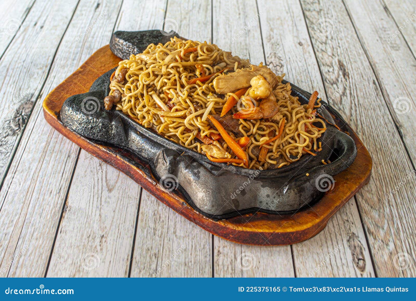 mixed chinese curly noodles with sauteed vegetables, with meat and with prawns