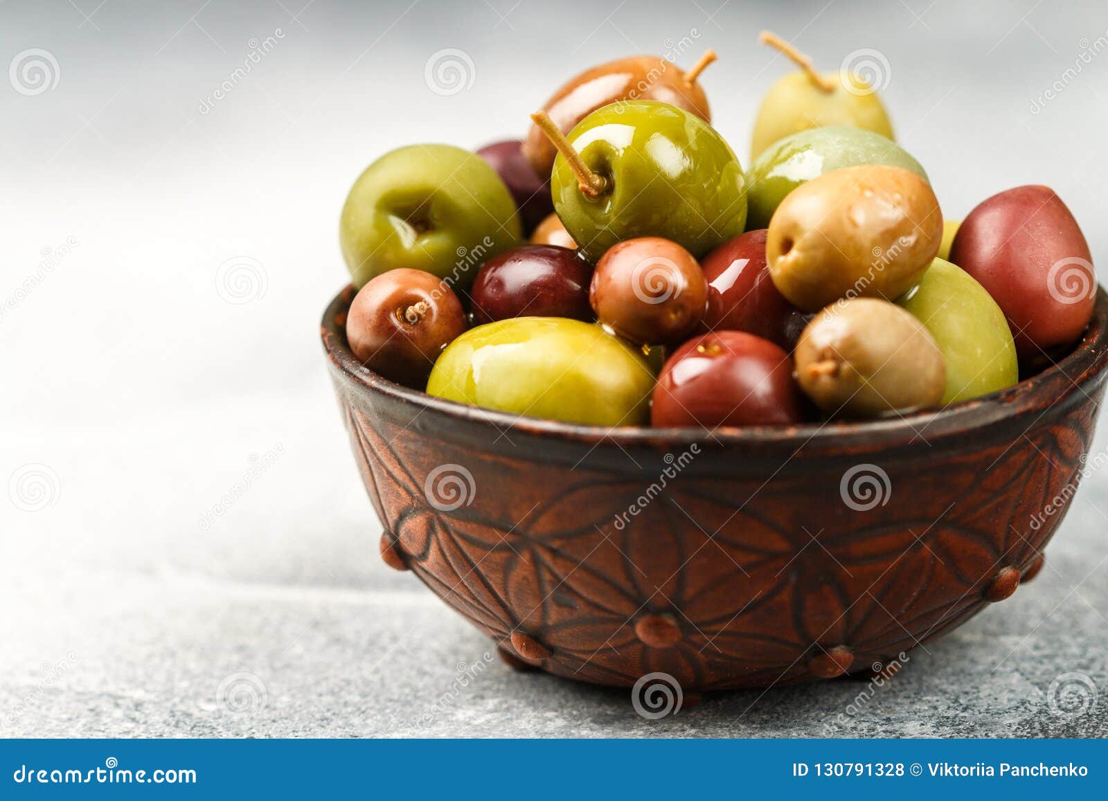 Mixed Marinated Olives Green and Purple in Ceramic Bowl Stock Photo