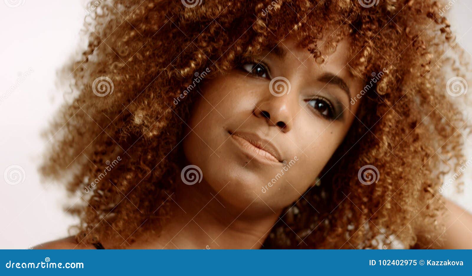 Mixed Race Black Woman With Blonde Curly Hair In Studio Stock