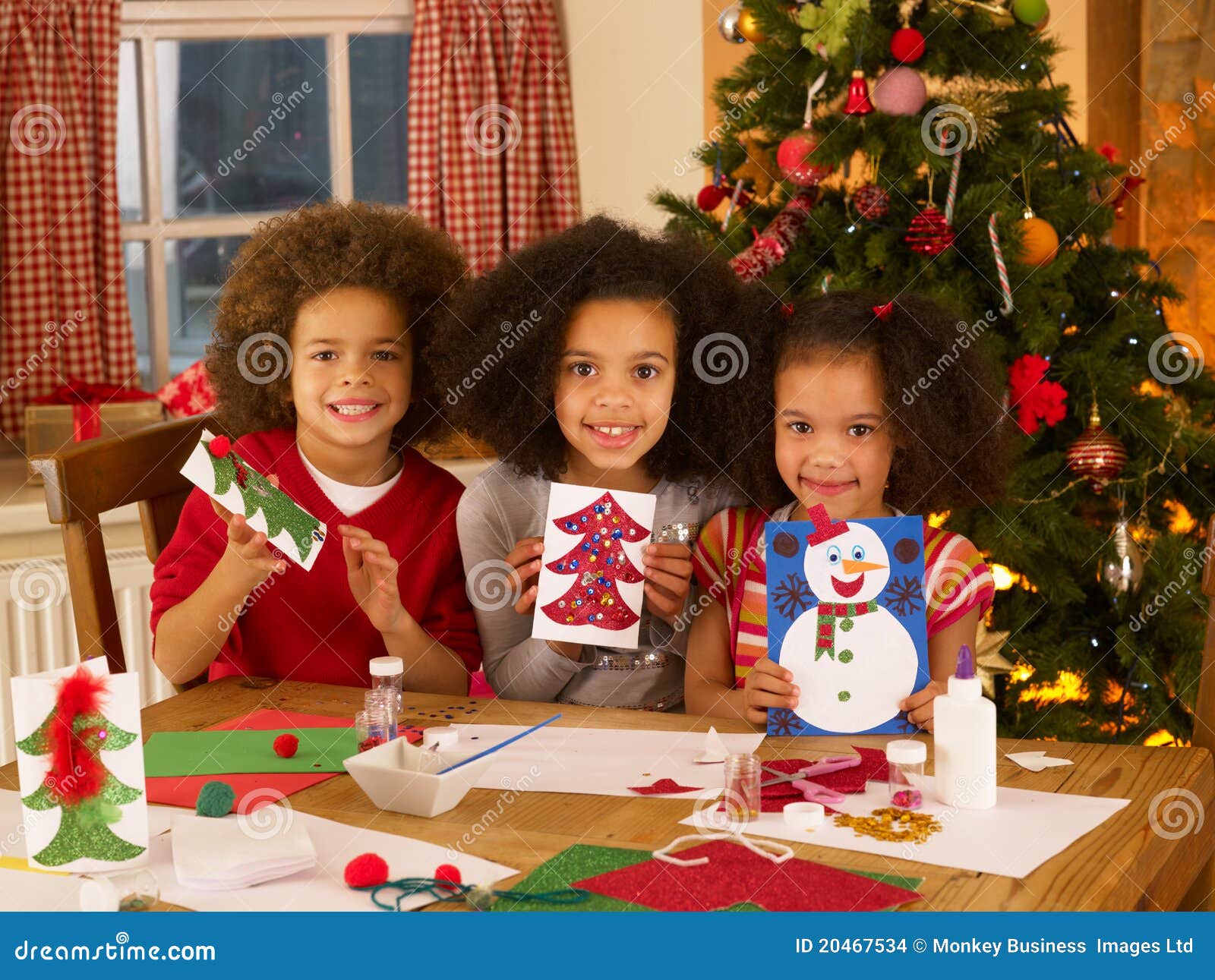 mixed race children making christmas cards