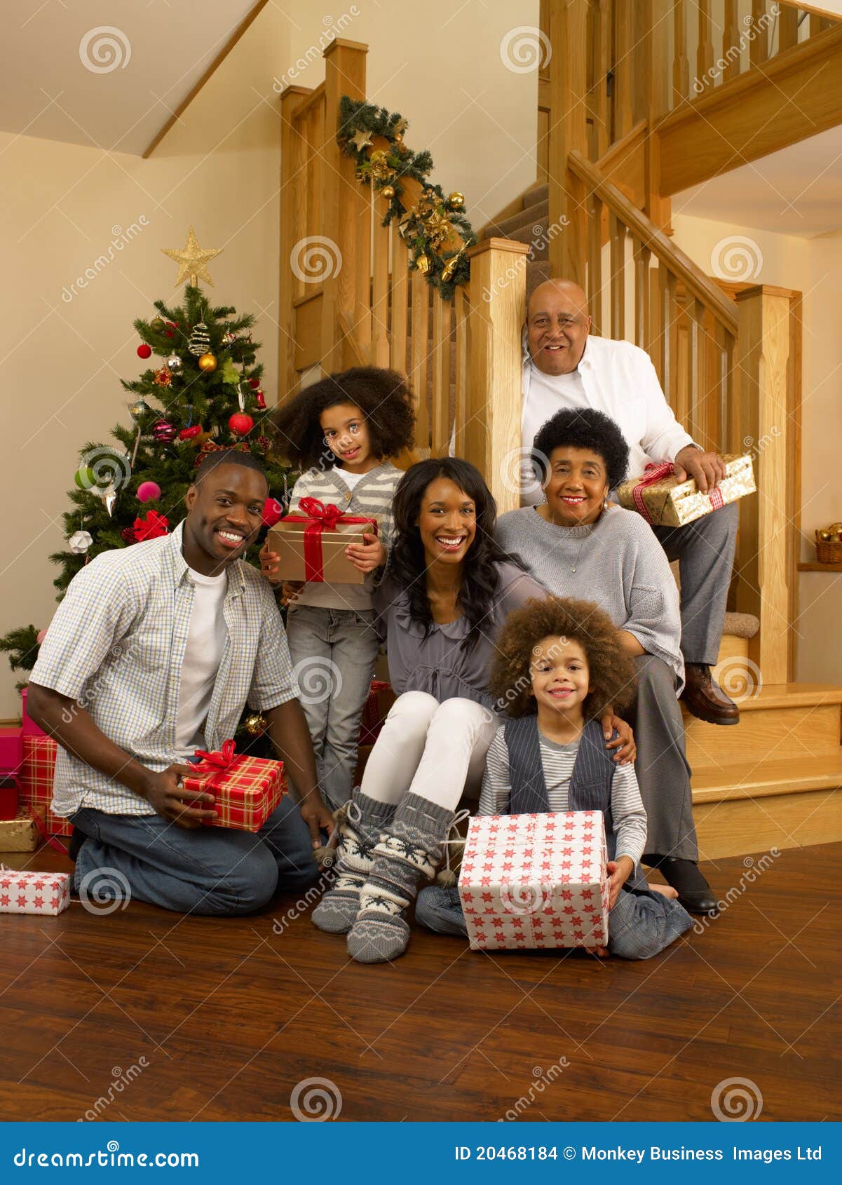 mixed race family exchanging gifts at christmas