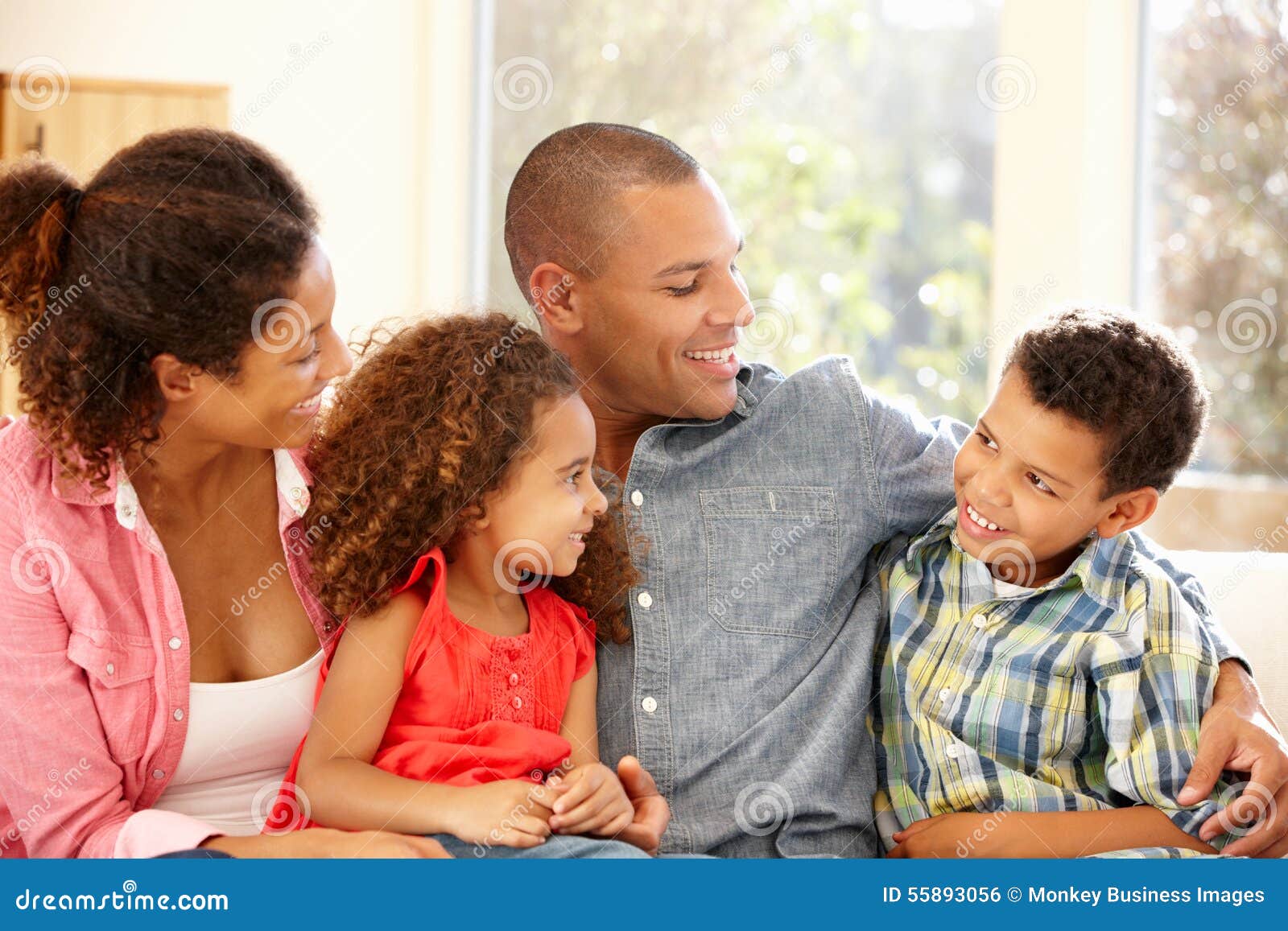 Mixed race family at home stock photo. Image of couch 55893056