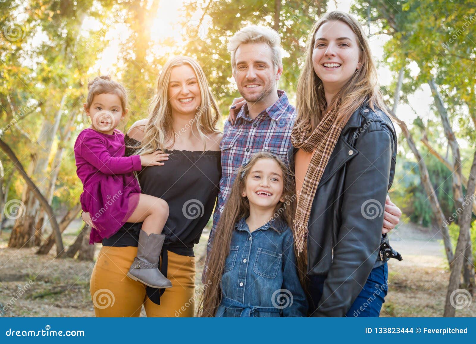 Mixed Race Family Members Having Fun Outdoors Stock Photo - Image of