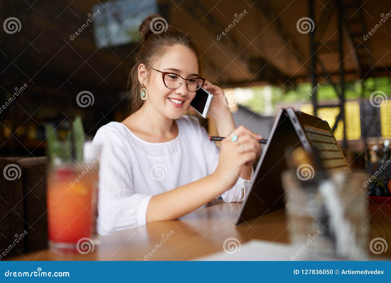 Mixed Race Freelancer Working with Convertible Laptop and Talking on ...