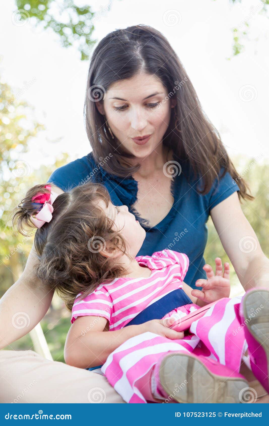 Mixed Race Mother And Cute Baby Daughter Playing With Cell Phone
