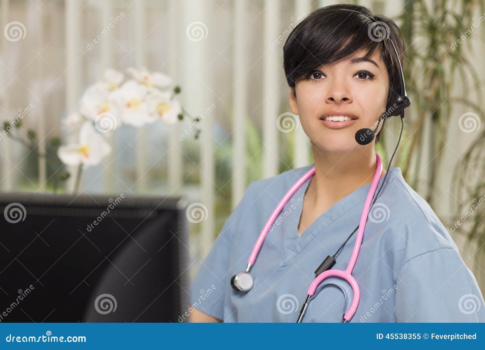 mixed race nurse practitioner or doctor at computer