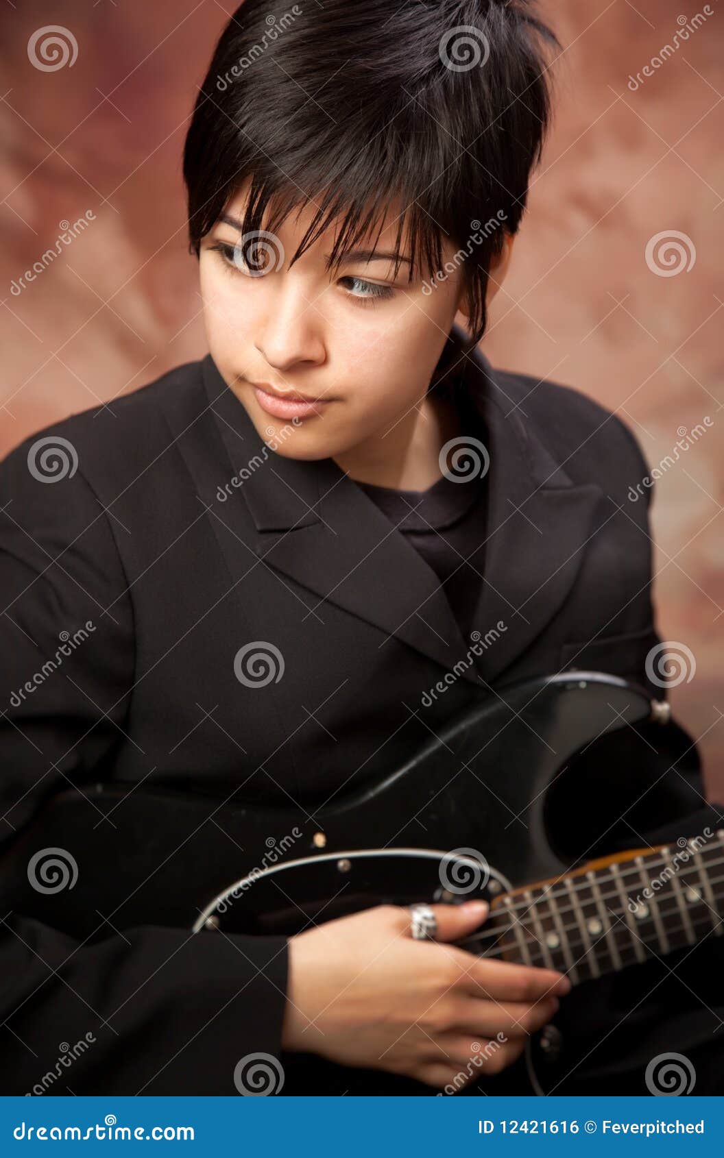 Portrait of young girl in jeans and knitted sweater with guitar sits on  couch and looks out window. An authentic scene. Young hipster musician  Stock Photo - Alamy