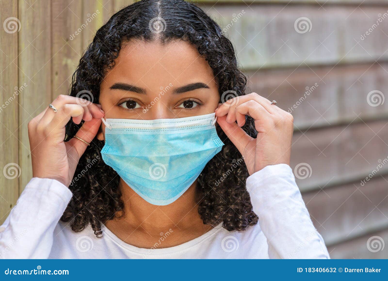 Mixed Race Teenager Girl Woman Wearing Adjusting Coronavirus COVID-19 ...