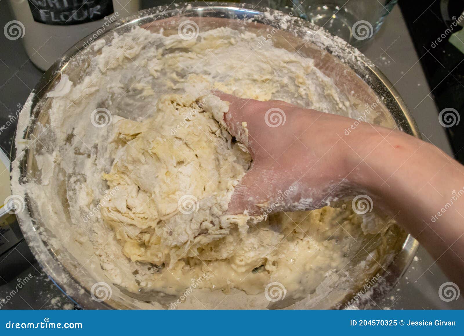 Bowl of mixing dough in messy kitchen - Stock Image - F005/2392