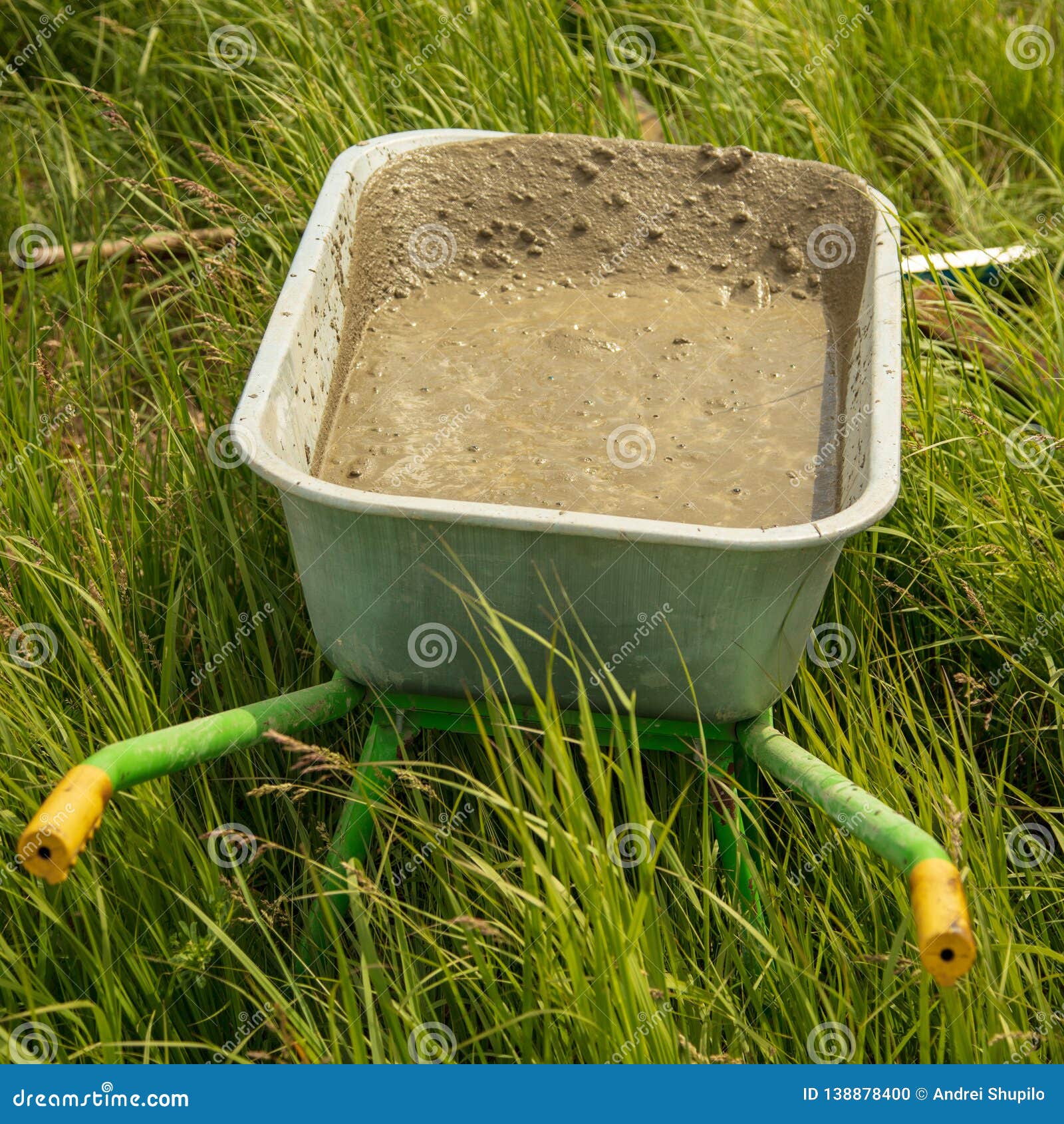 Mixture of Concrete in a Wheelbarrow at a Construction Site Stock Photo